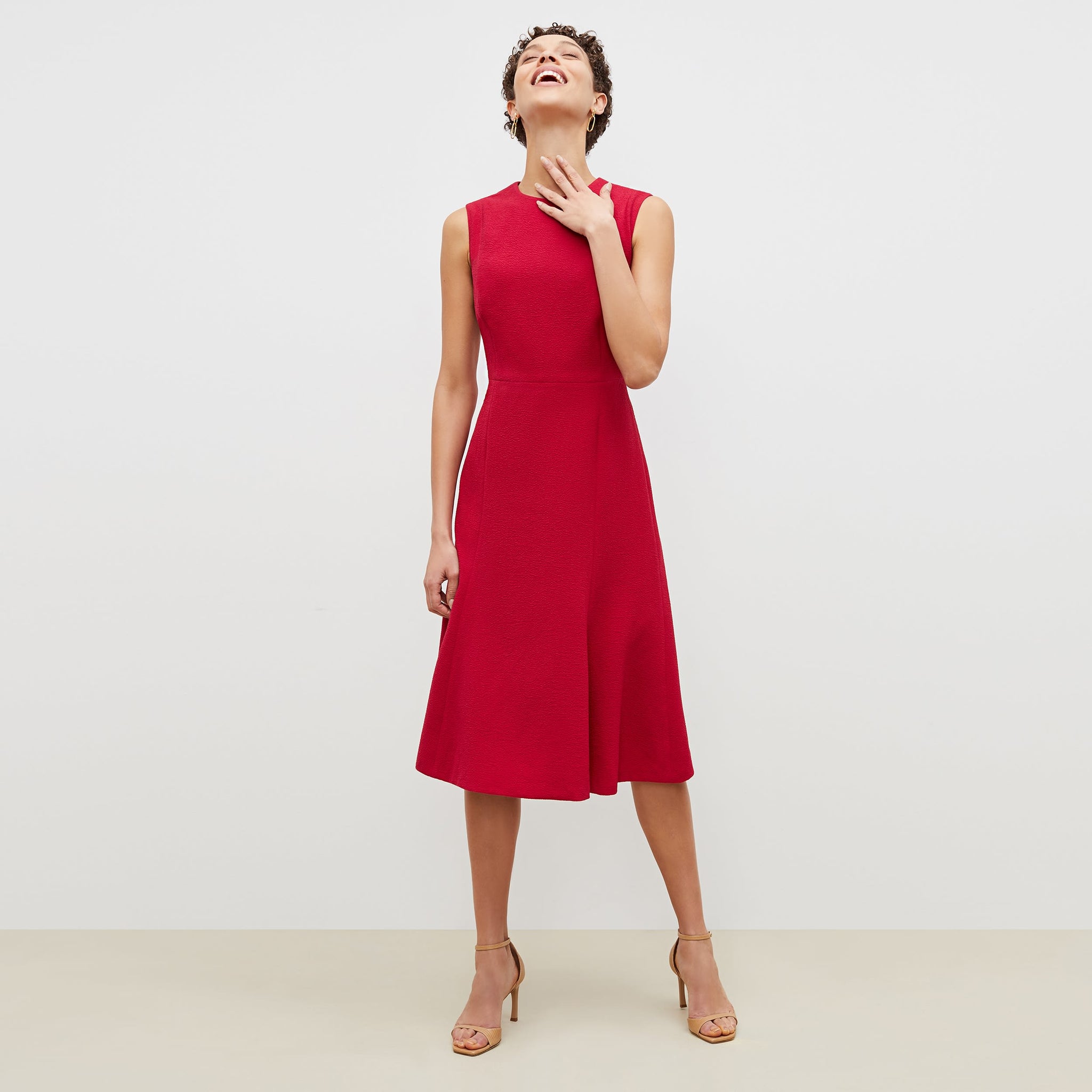 Front image of a woman standing wearing the jane dress in staccato in hibiscus