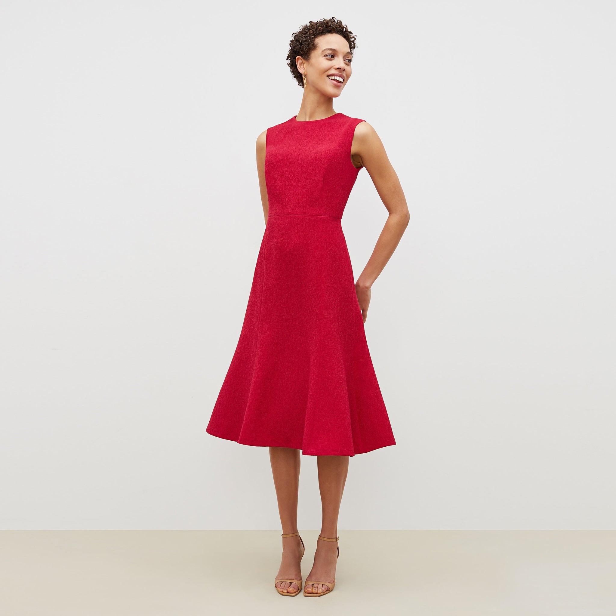 Front image of a woman standing wearing the jane dress in staccato in hibiscus 