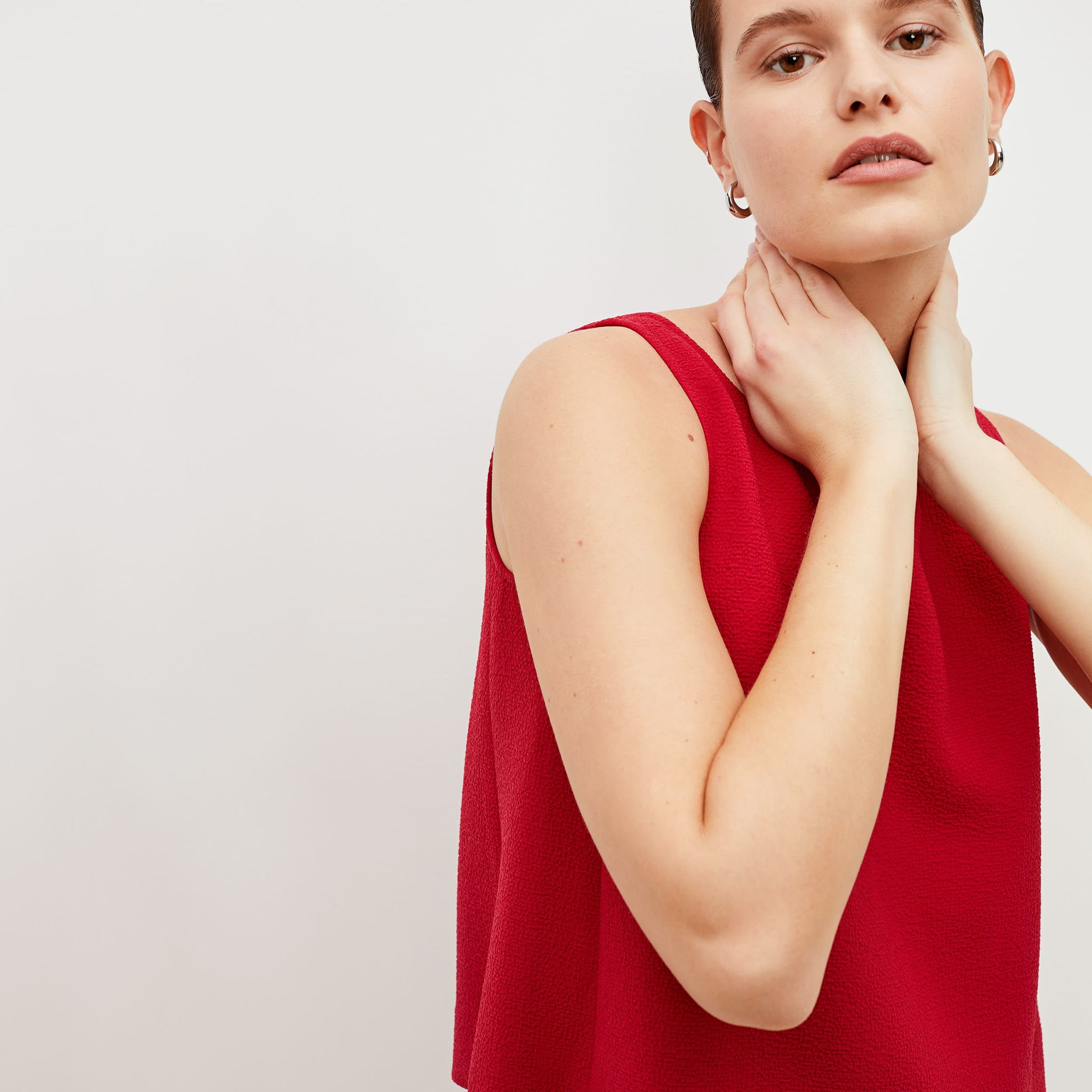 Detail image of a woman standing wearing the flaka top in staccato in hibiscus