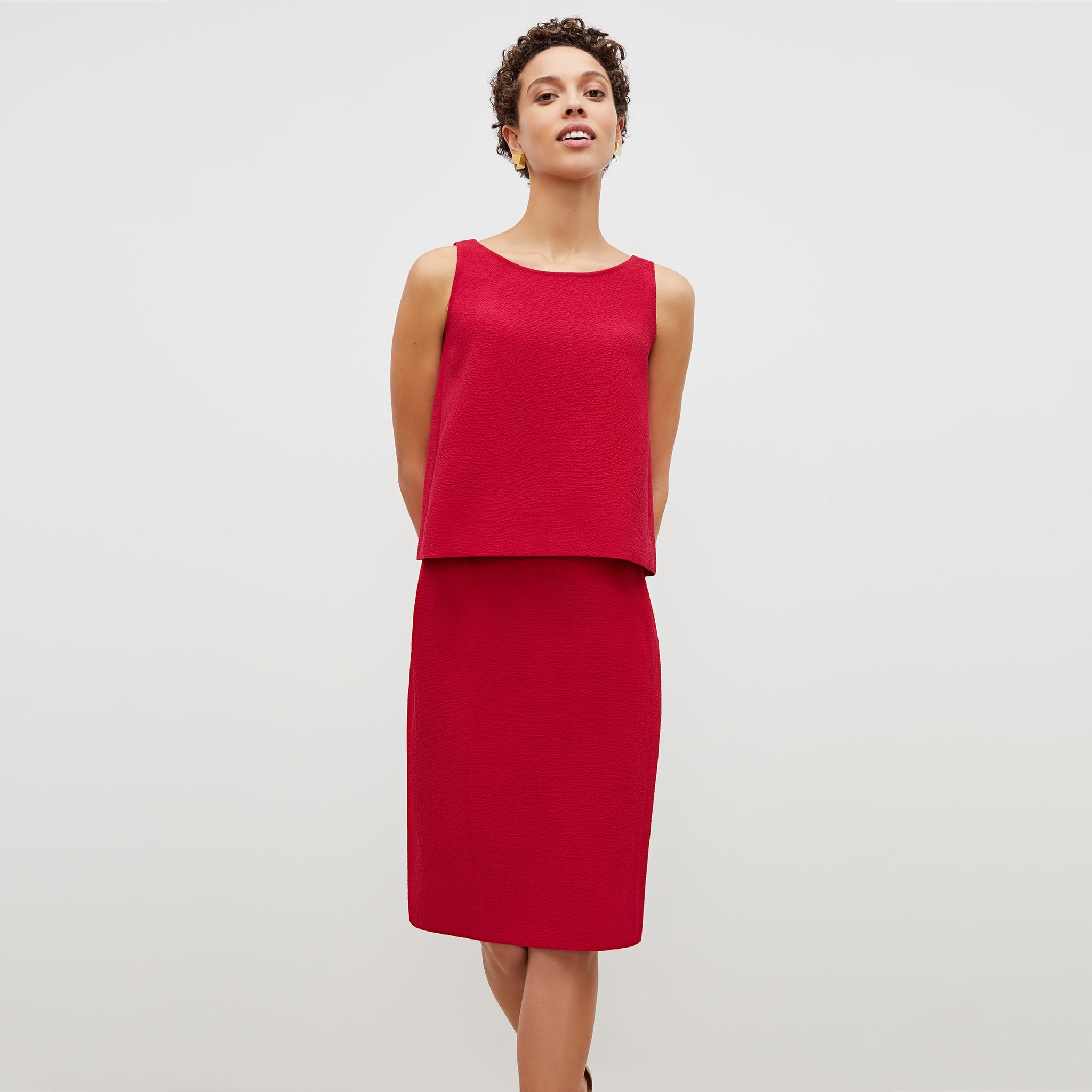 Front image of a woman standing wearing the flaka top in staccato in hibiscus