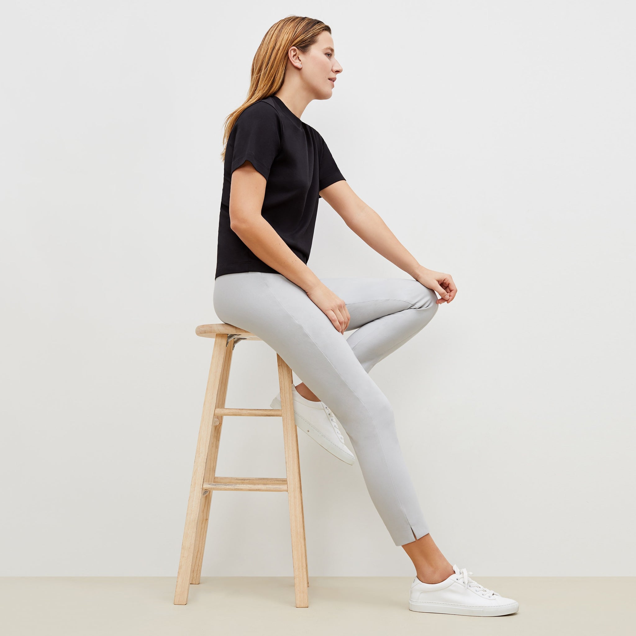 Side image of a woman standing wearing the marais pant in quartz
