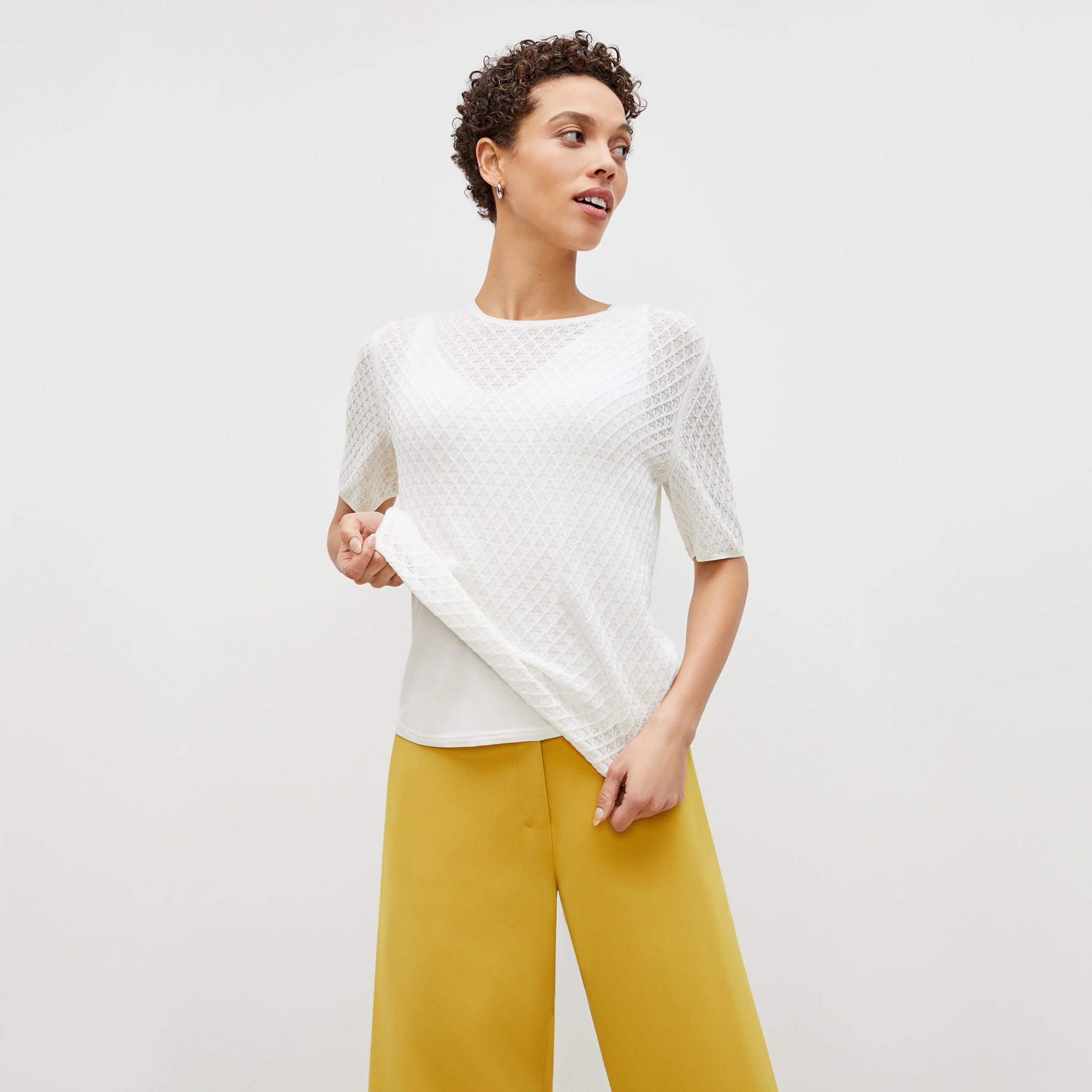 Front image of a woman standing wearing the natalie top in ivory