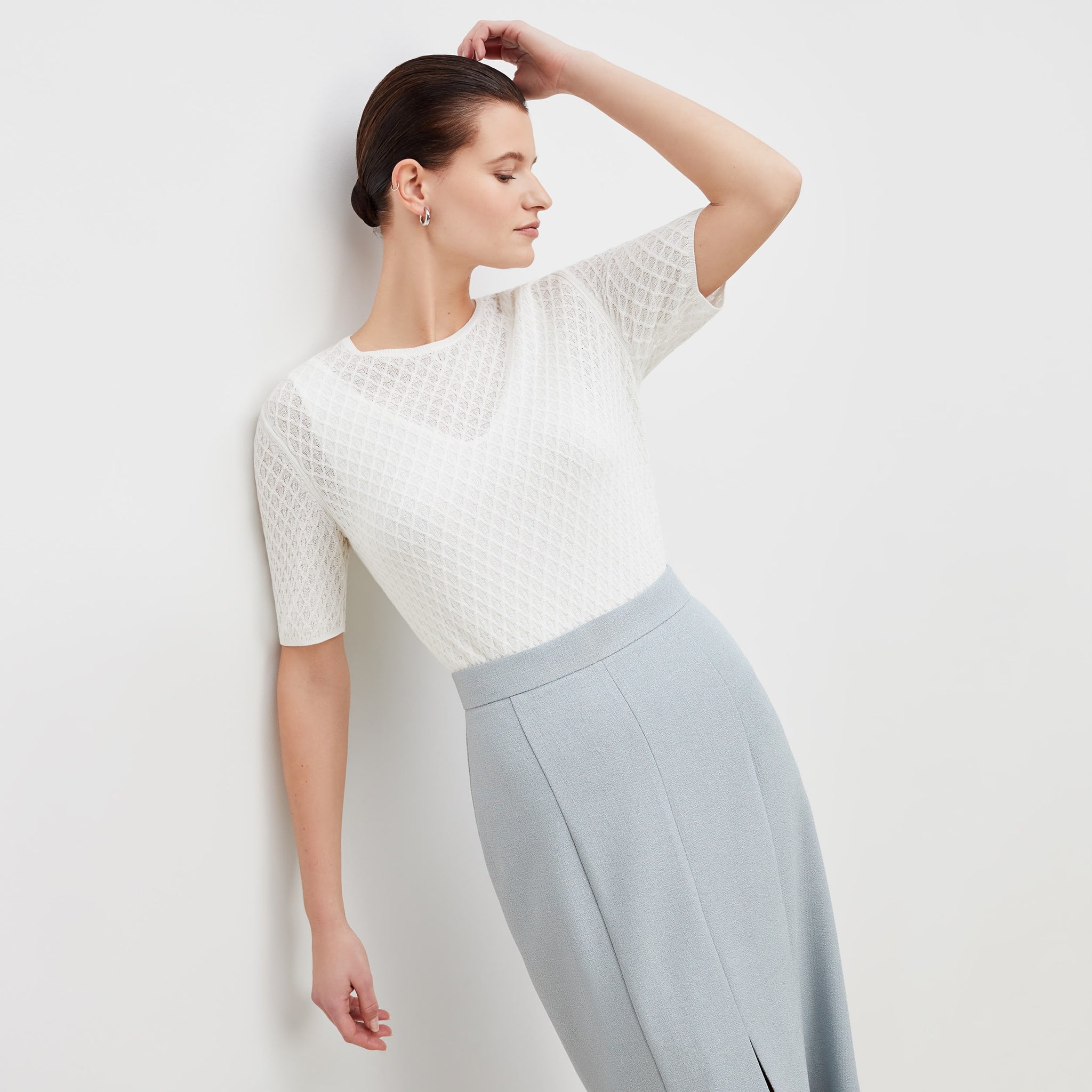Front image of a woman standing wearing the natalie top in ivory