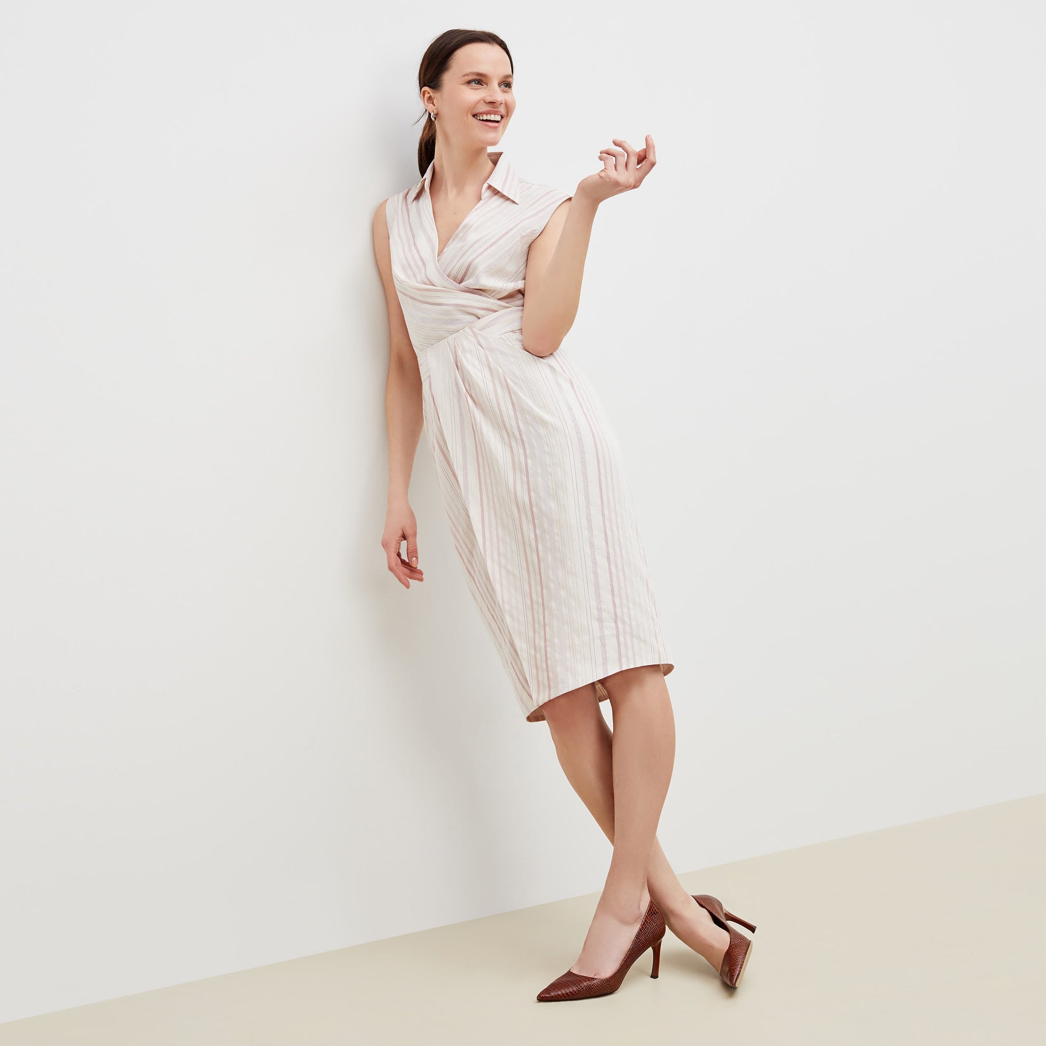 Front image of a woman standing wearing the lenox skirt in twill stripe in ivory / red 