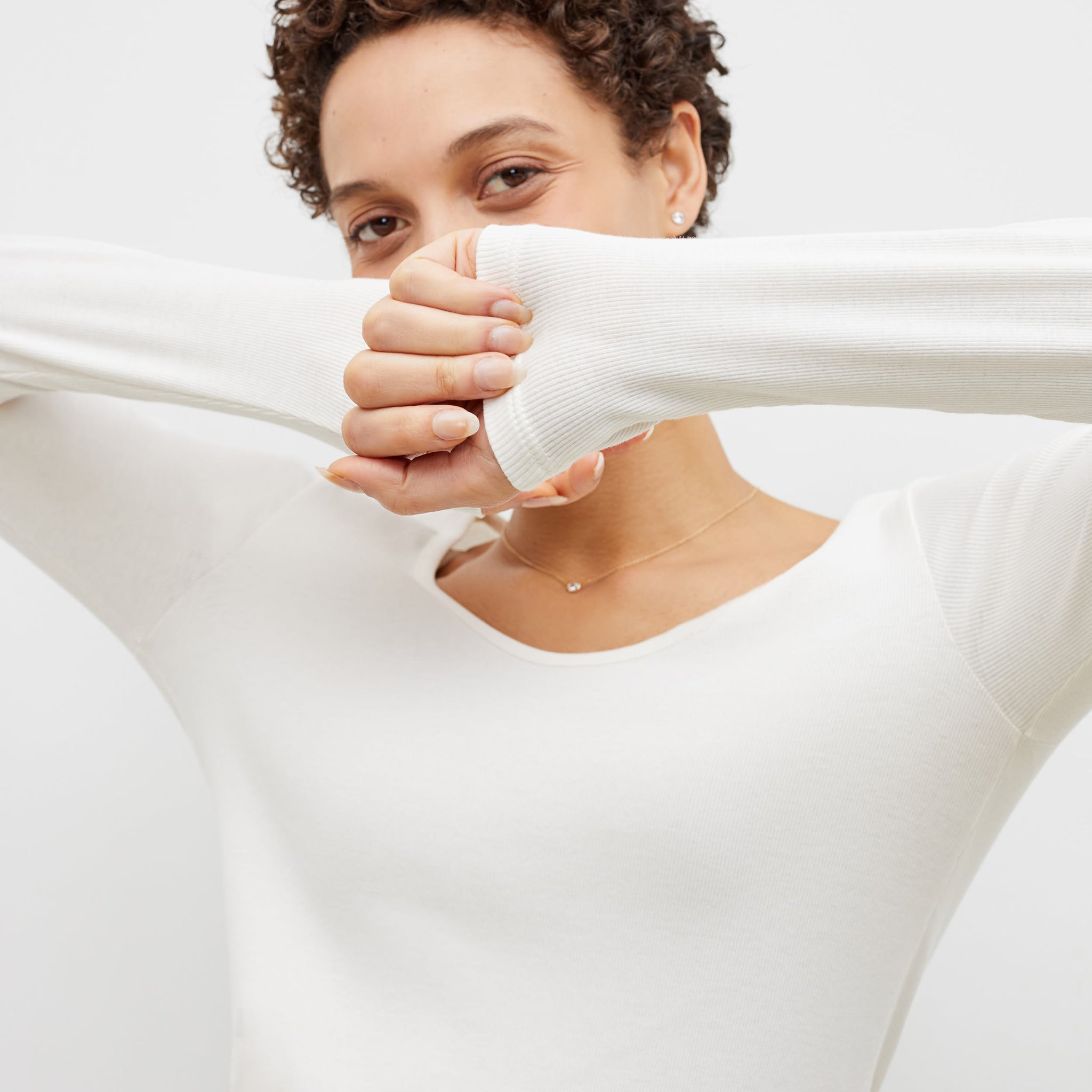 Detail image of a woman standing wearing the marcia top in fine ribbed cotton in ivory