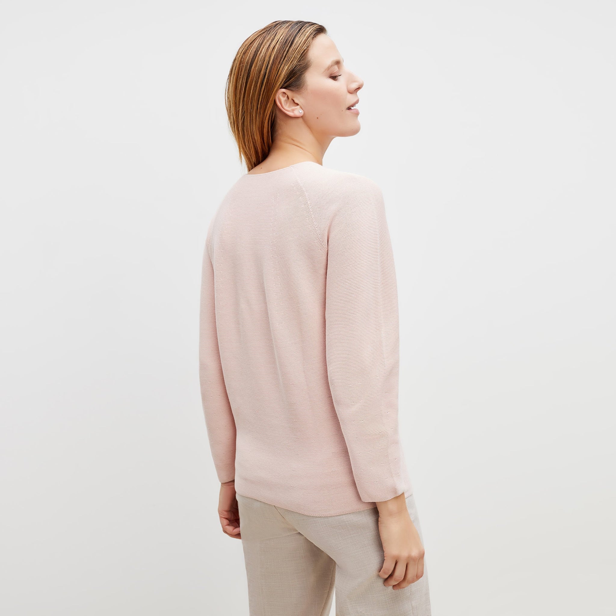 Back image of a woman standing wearing the chadwick top in peony