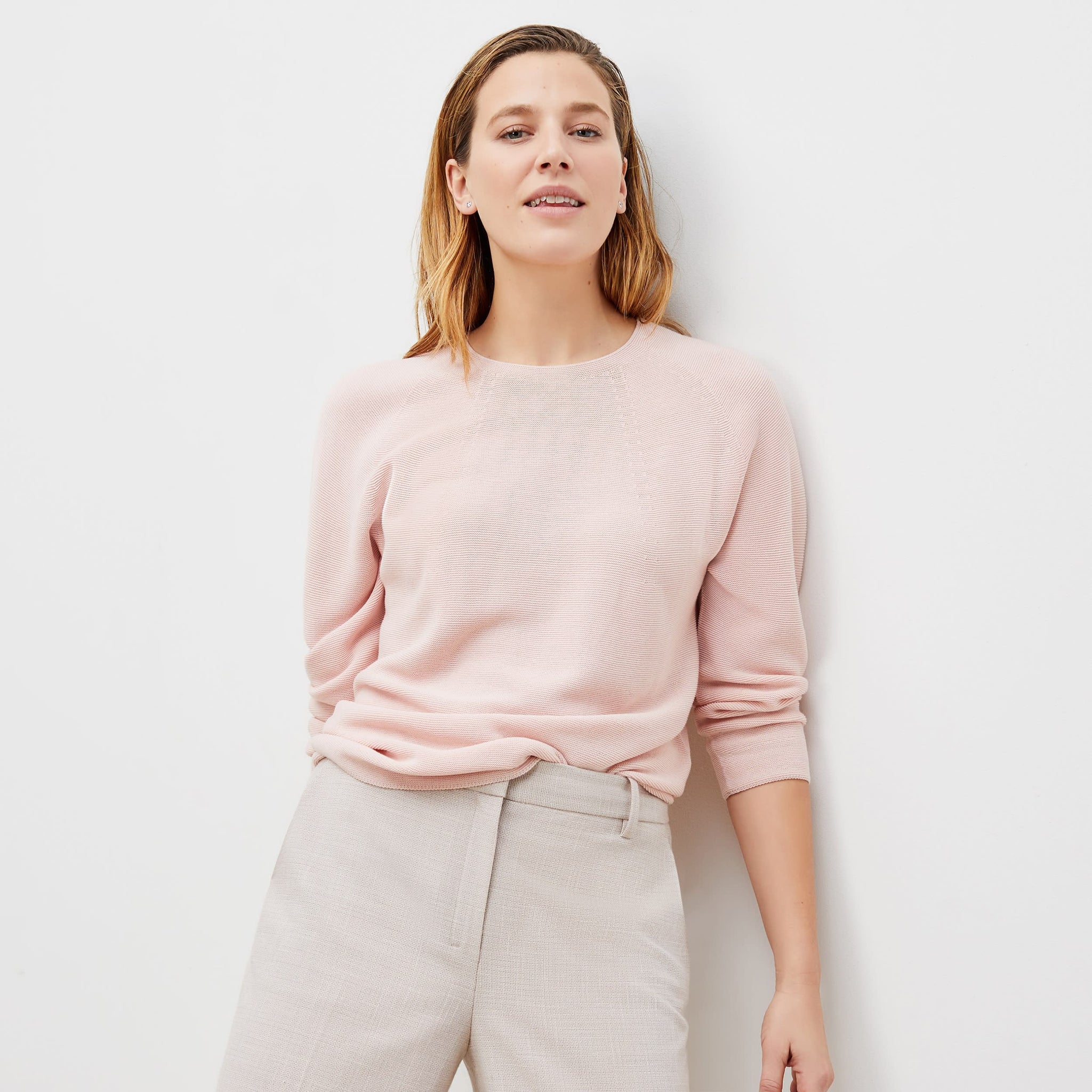 Front image of a woman standing wearing the chadwick top in peony 