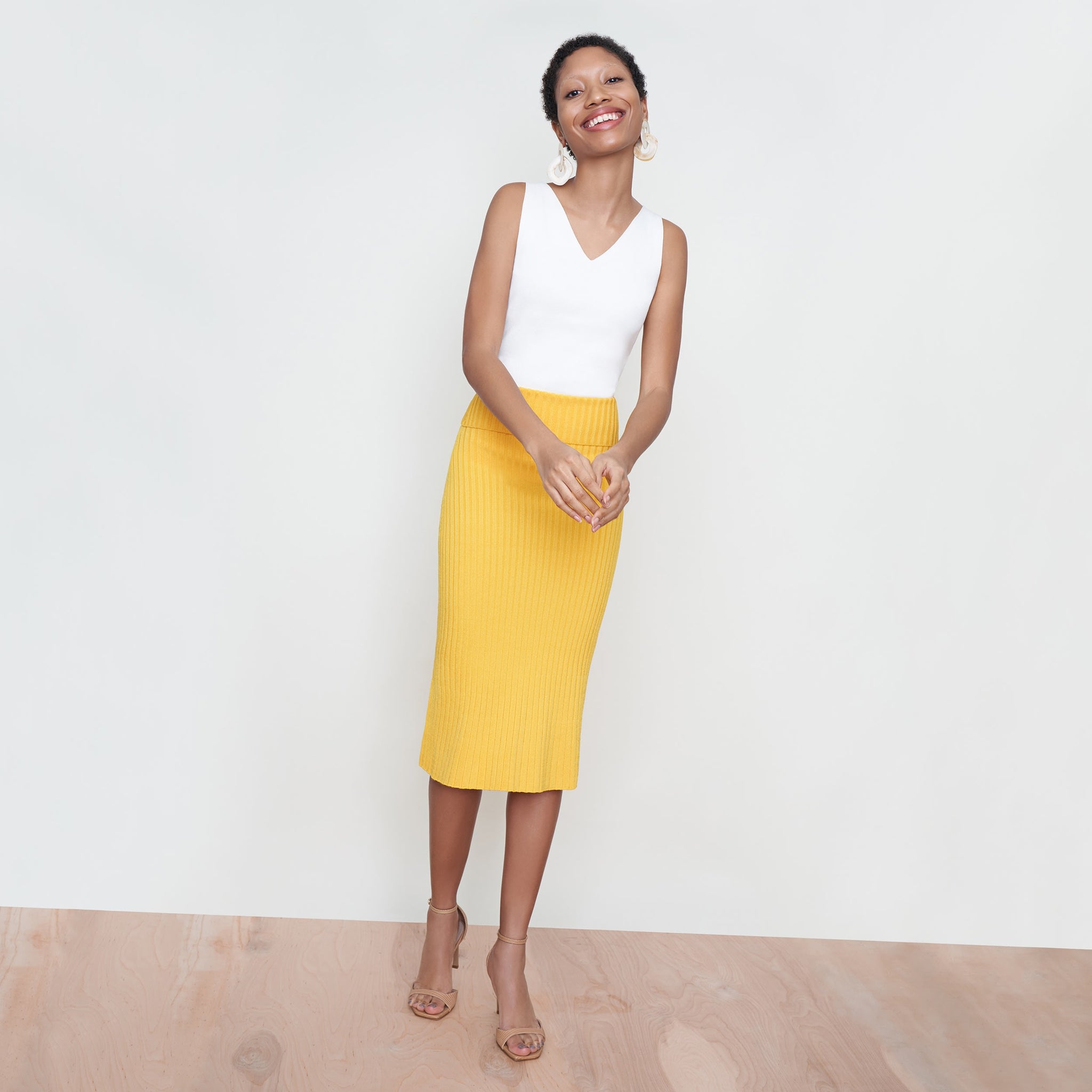 Front image of a woman standing wearing the York Skirt in Tuscan Yellow