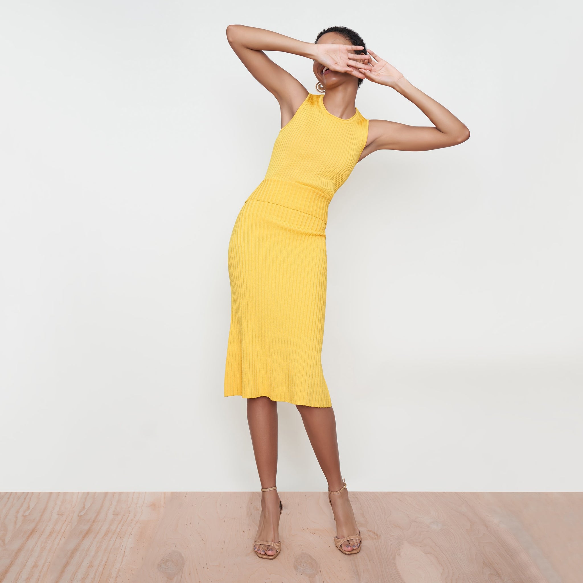 Front image of a woman standing wearing the York Skirt in Tuscan Yellow