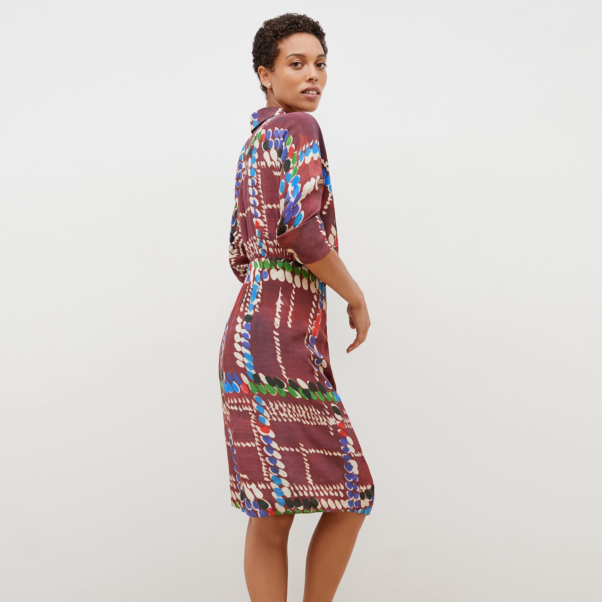 Back image of a woman standing wearing the june dress dash plaid in multicolor