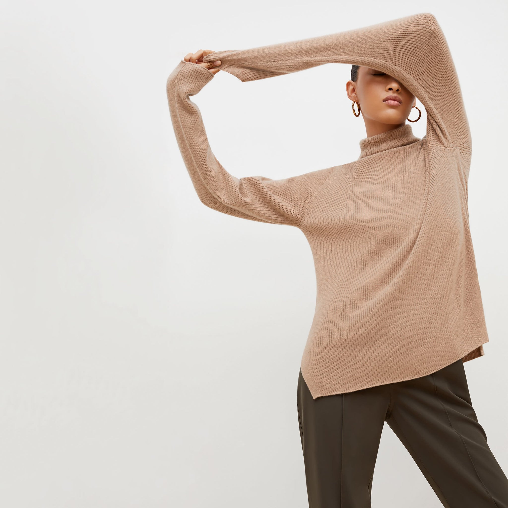 front image of a woman wearing the mckenzie sweater in deep flax