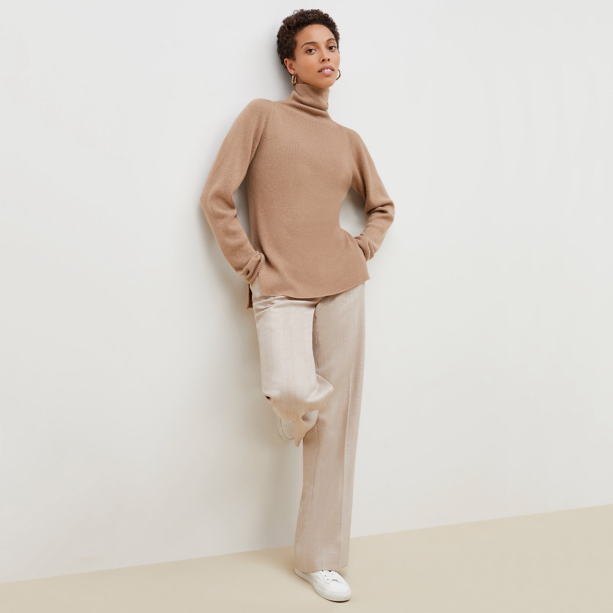 front image of a woman wearing the mckenzie sweater in deep flax 