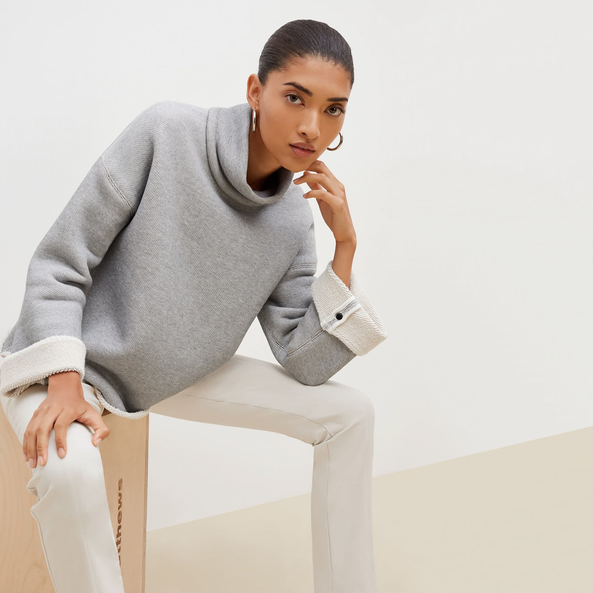 Front image of a woman sitting wearing the Sharon Top—Plush Terry in Gray / Ivory 