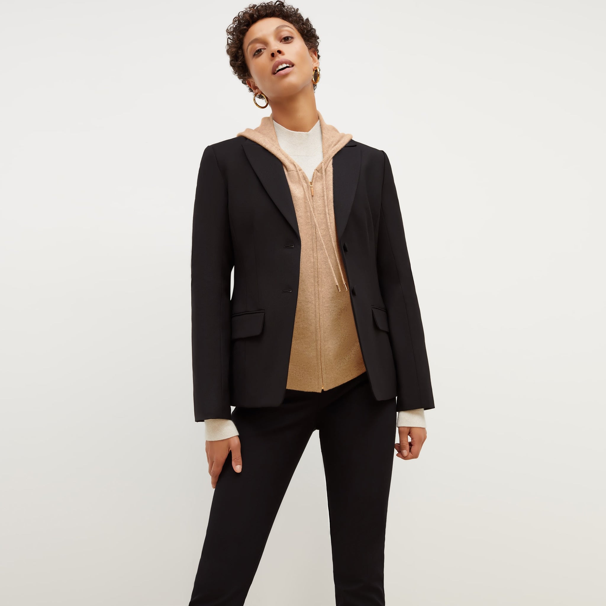Front image of a woman standing wearing the bennett blazer wool twill in black