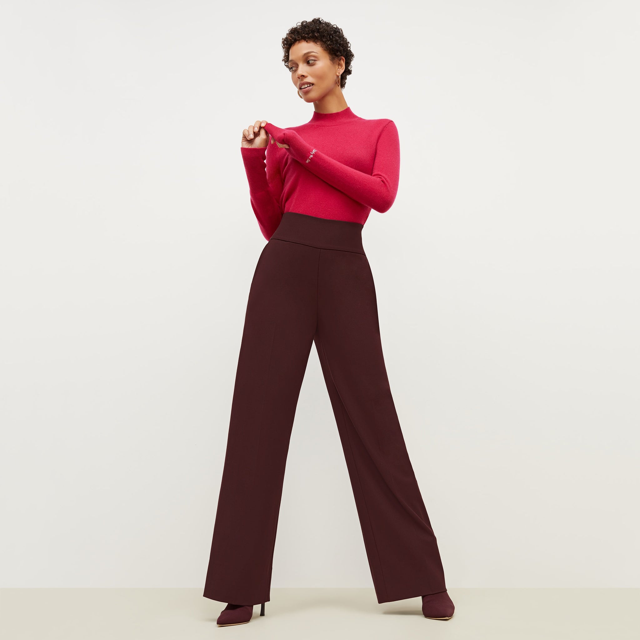 Front image of a woman standing wearing the Hadley Pant-Sharkskin in garnet