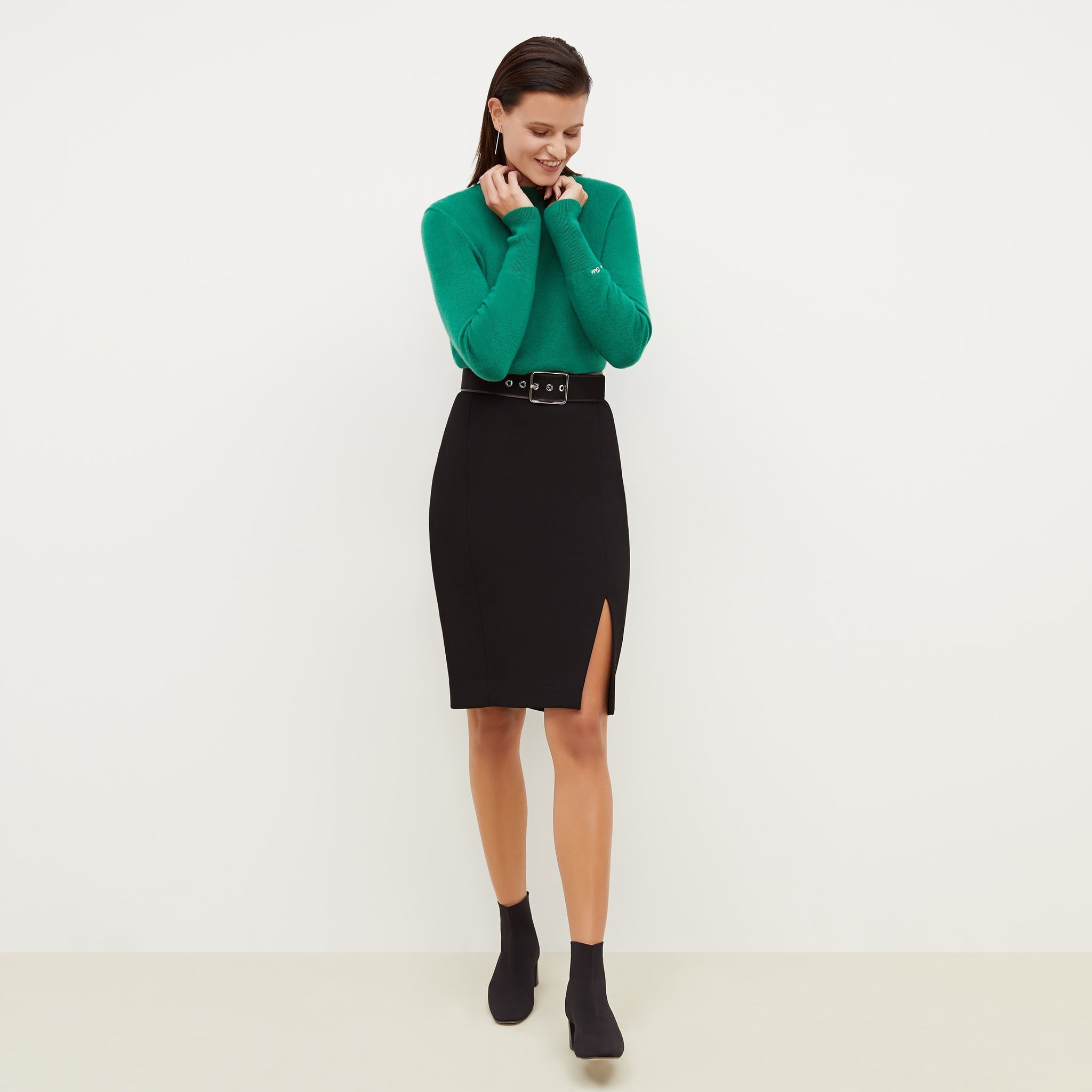 Front image of a woman standing wearing the Cortlandt Skirt--Worth in Black