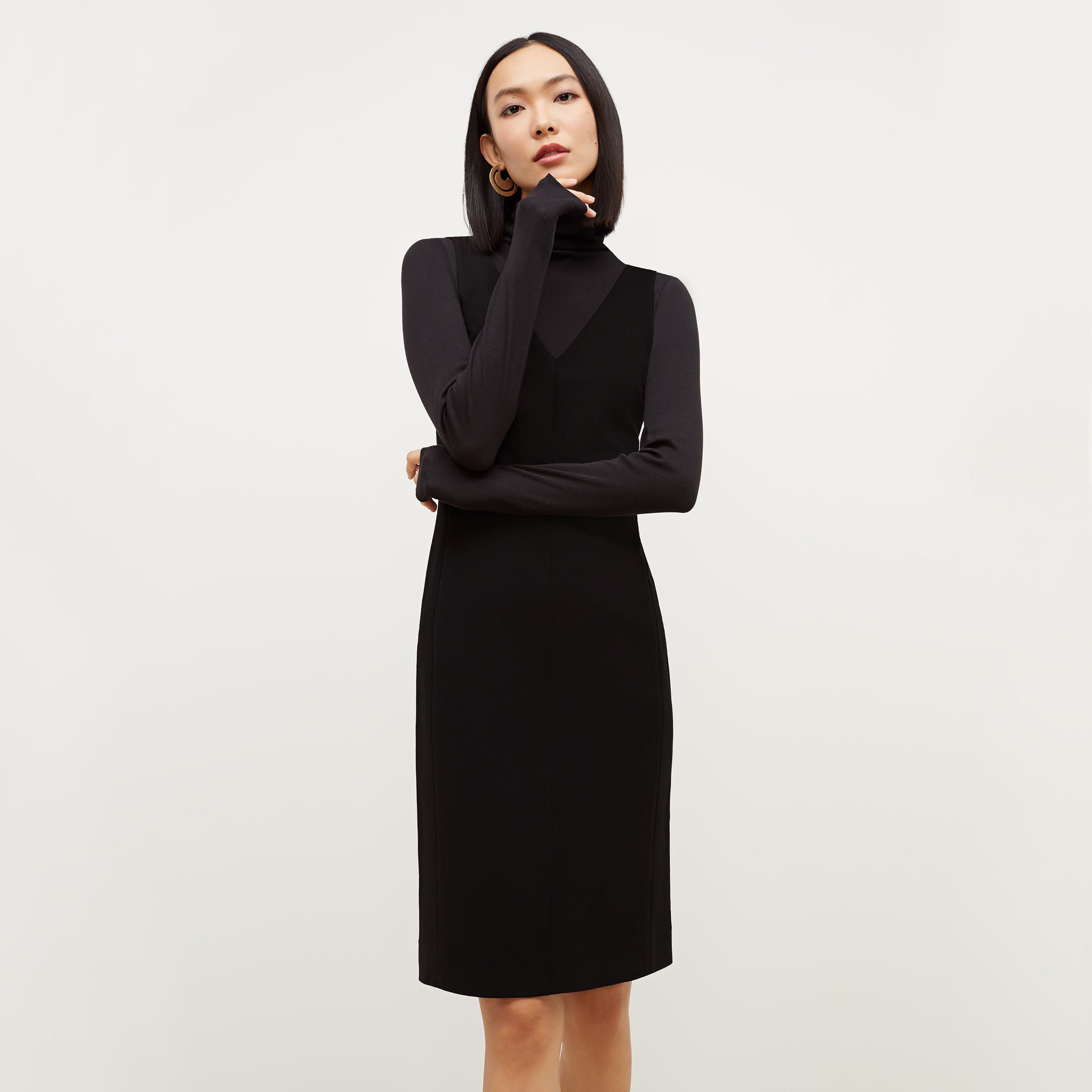 Front image of a woman standing wearing the Rachel dress in black