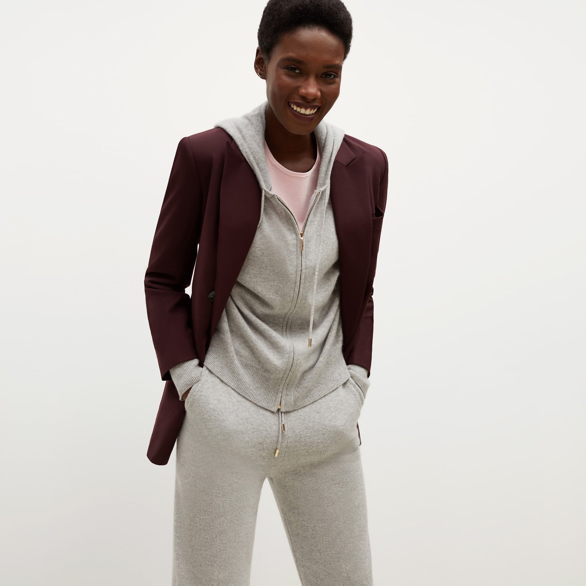 Front image of a woman standing wearing the Choe Top—365Knit in Rosewater