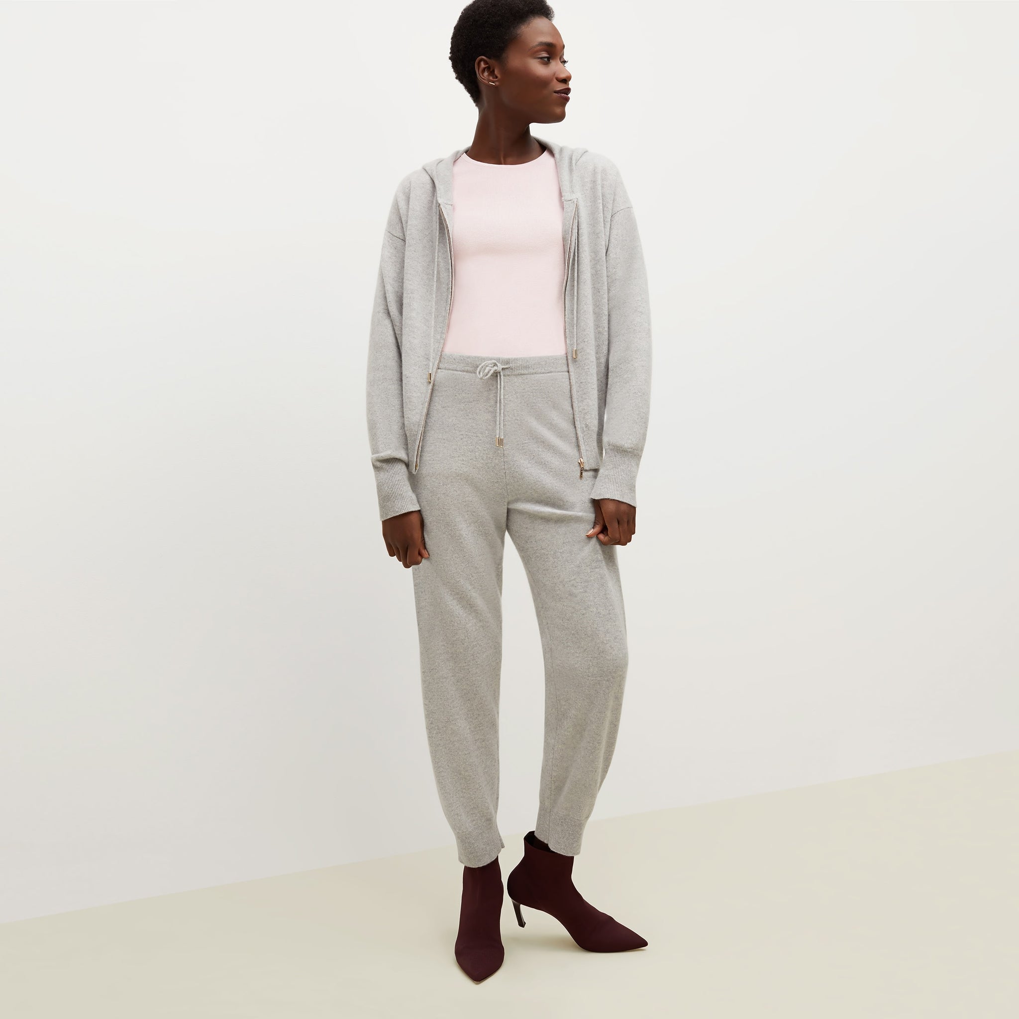 Front image of a woman standing wearing the Choe Top—365Knit in Rosewater