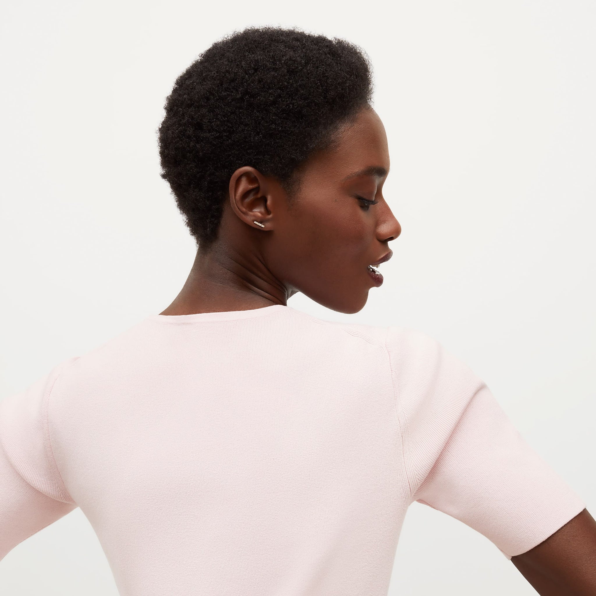 Back image of a woman standing wearing the Choe Top—365Knit in Rosewater