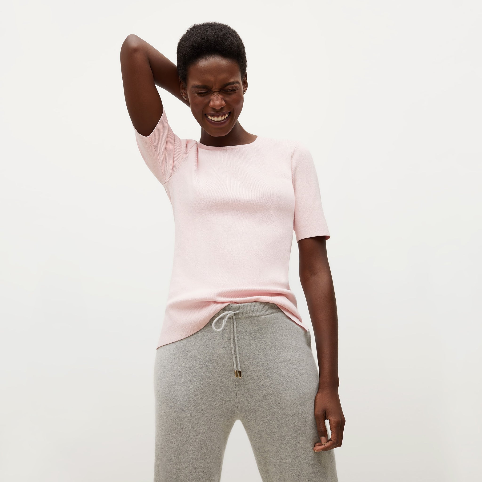 Front image of a woman standing wearing the Choe Top—365Knit in Rosewater 