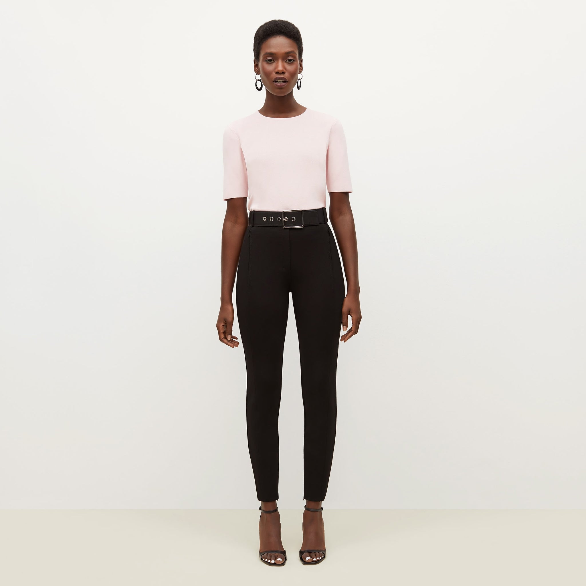 Front image of a woman standing wearing the Choe Top—365Knit in Rosewater