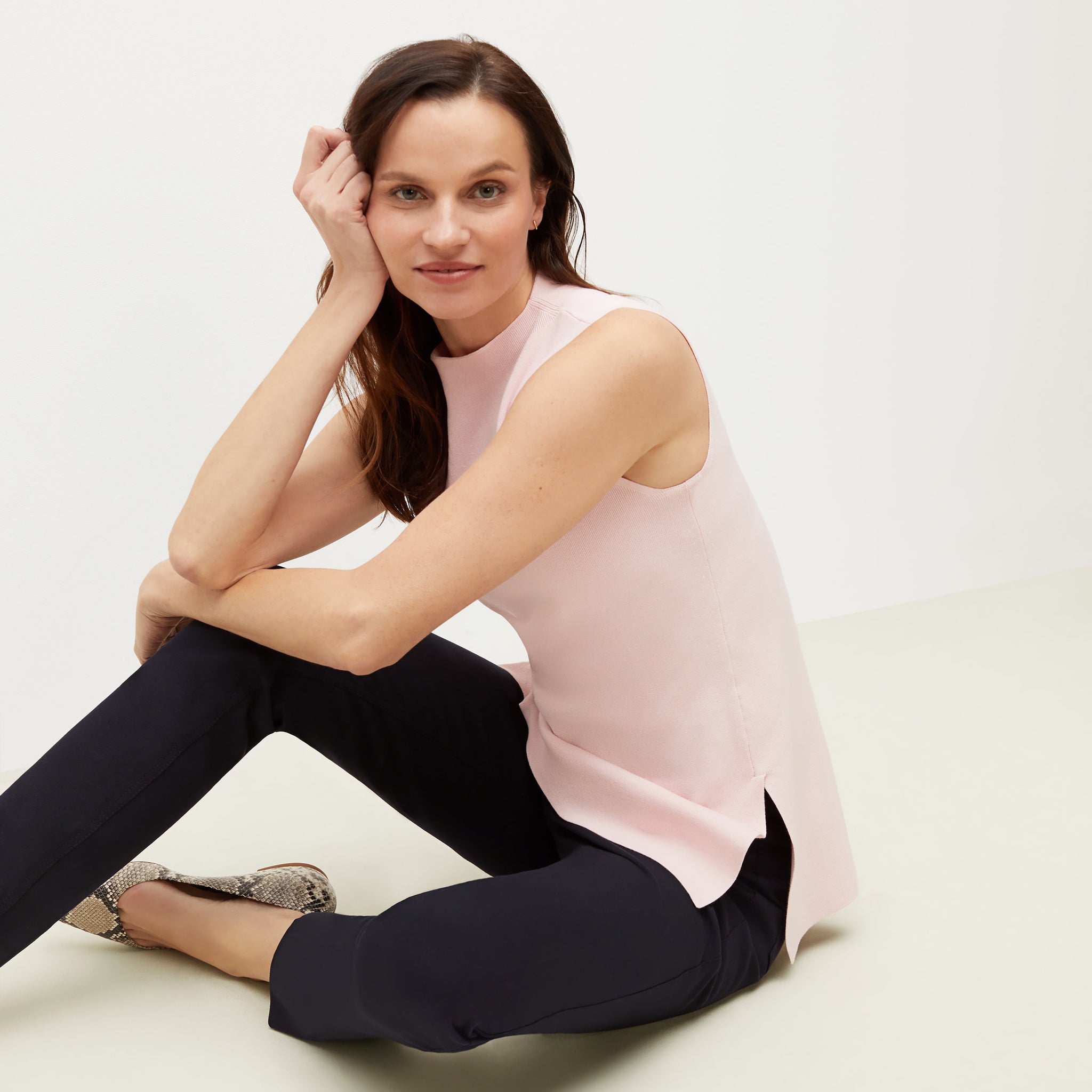 Side image of a woman sitting wearing the Giulia Top—365Knit in Rosewater