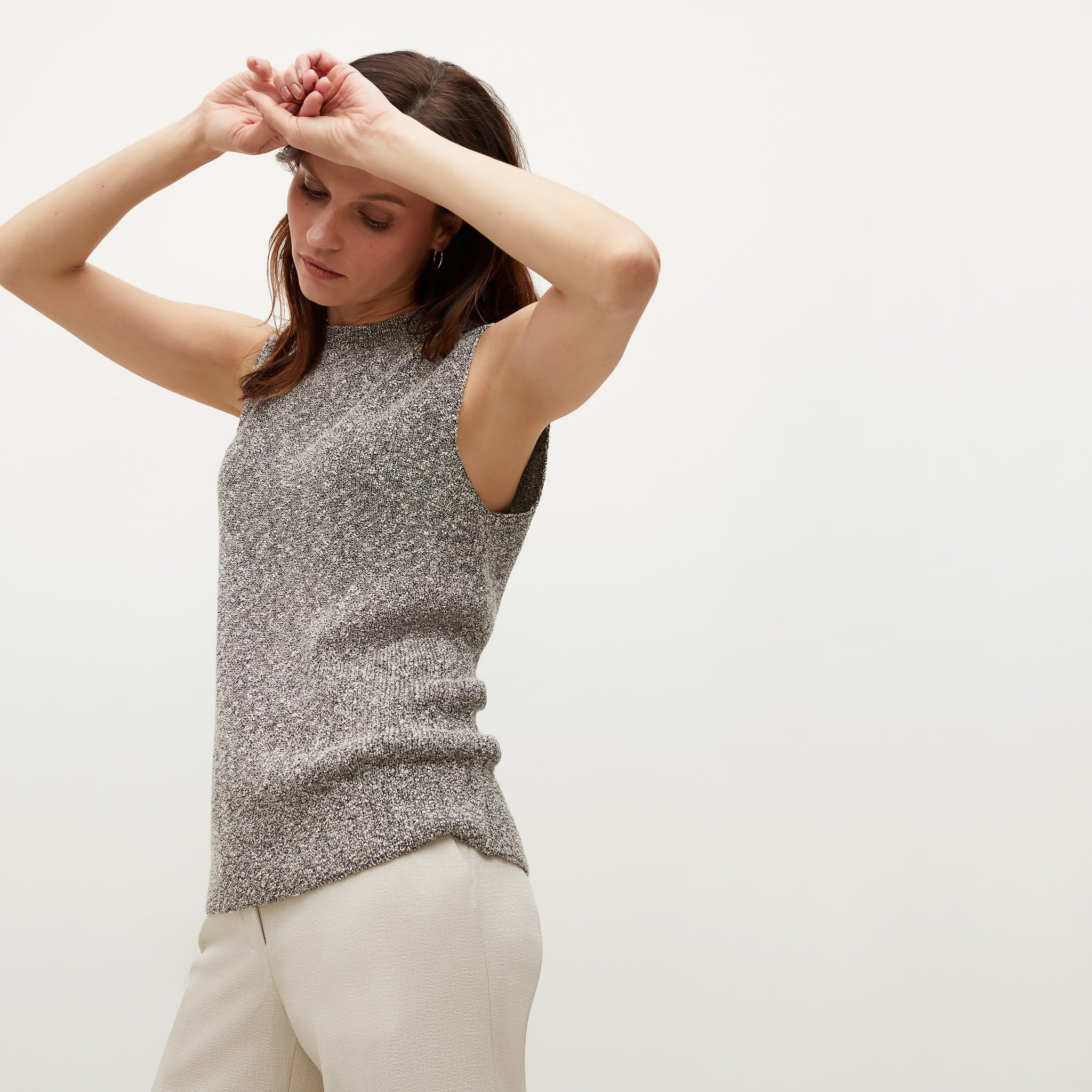 Side image of a woman standing wearing the Barbara Sweater—Knit Boucle in Black / White