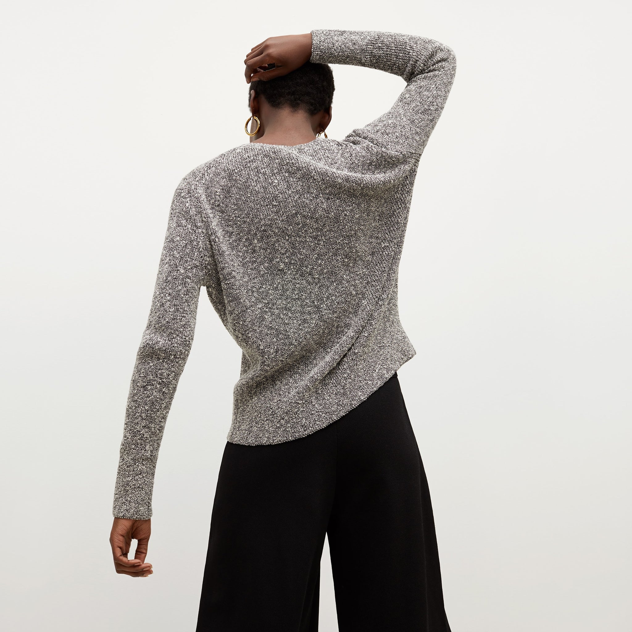 Back image of a woman standing wearing the Butler Sweater—Knit Boucle in Black / White
