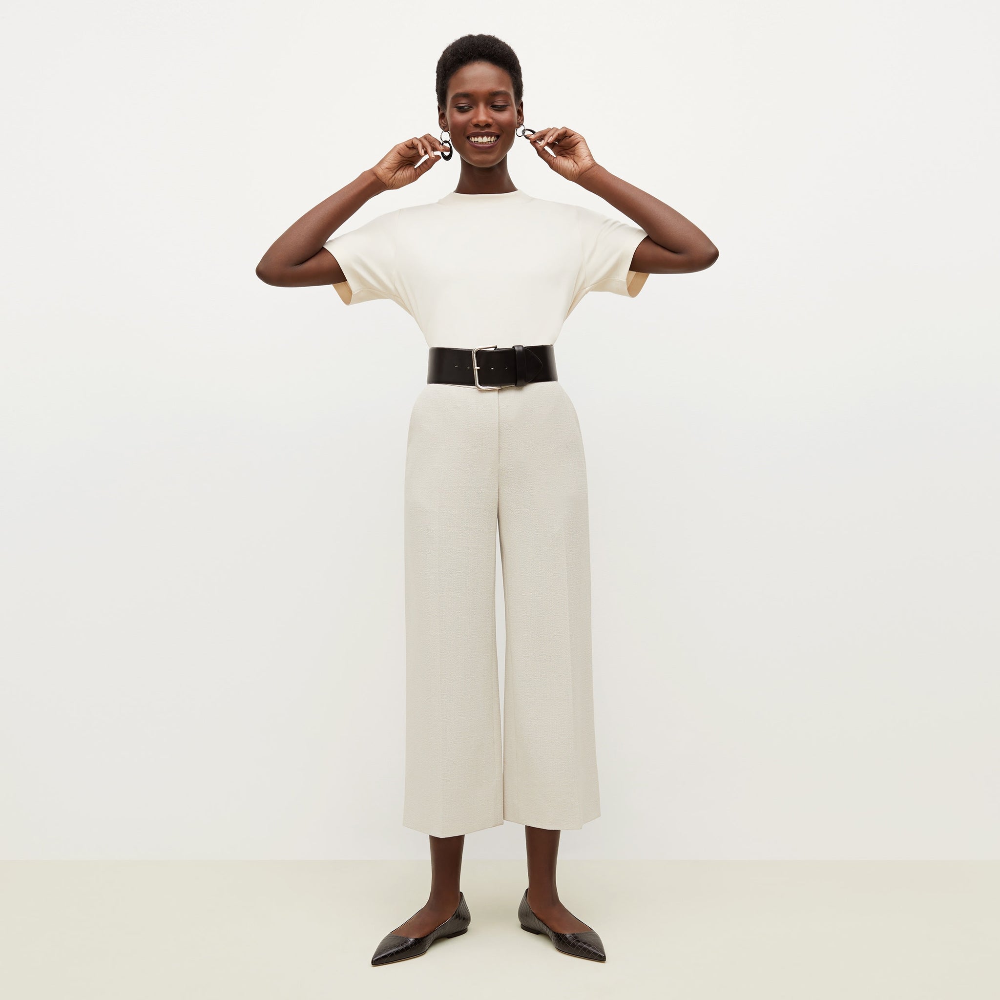 Front image of a woman standing wearing the anderson pant in textured suiting in magnolia