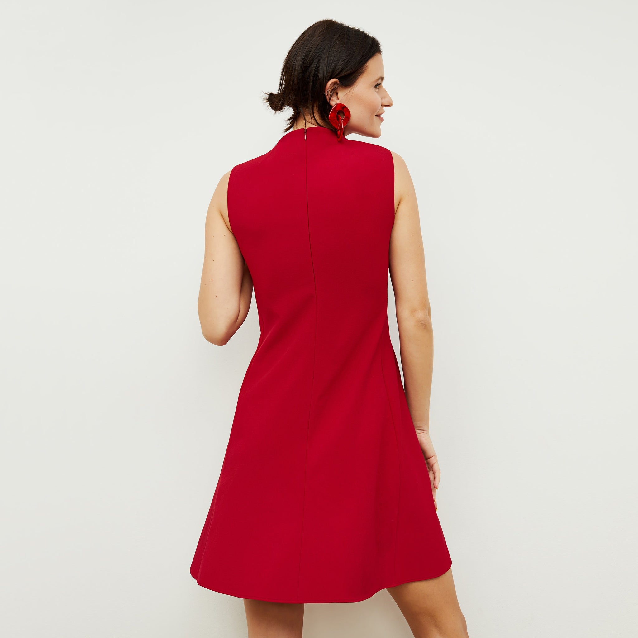 Back image of a woman standing wearing the Malala Dress—Recycled WonderTex in Rhubarb