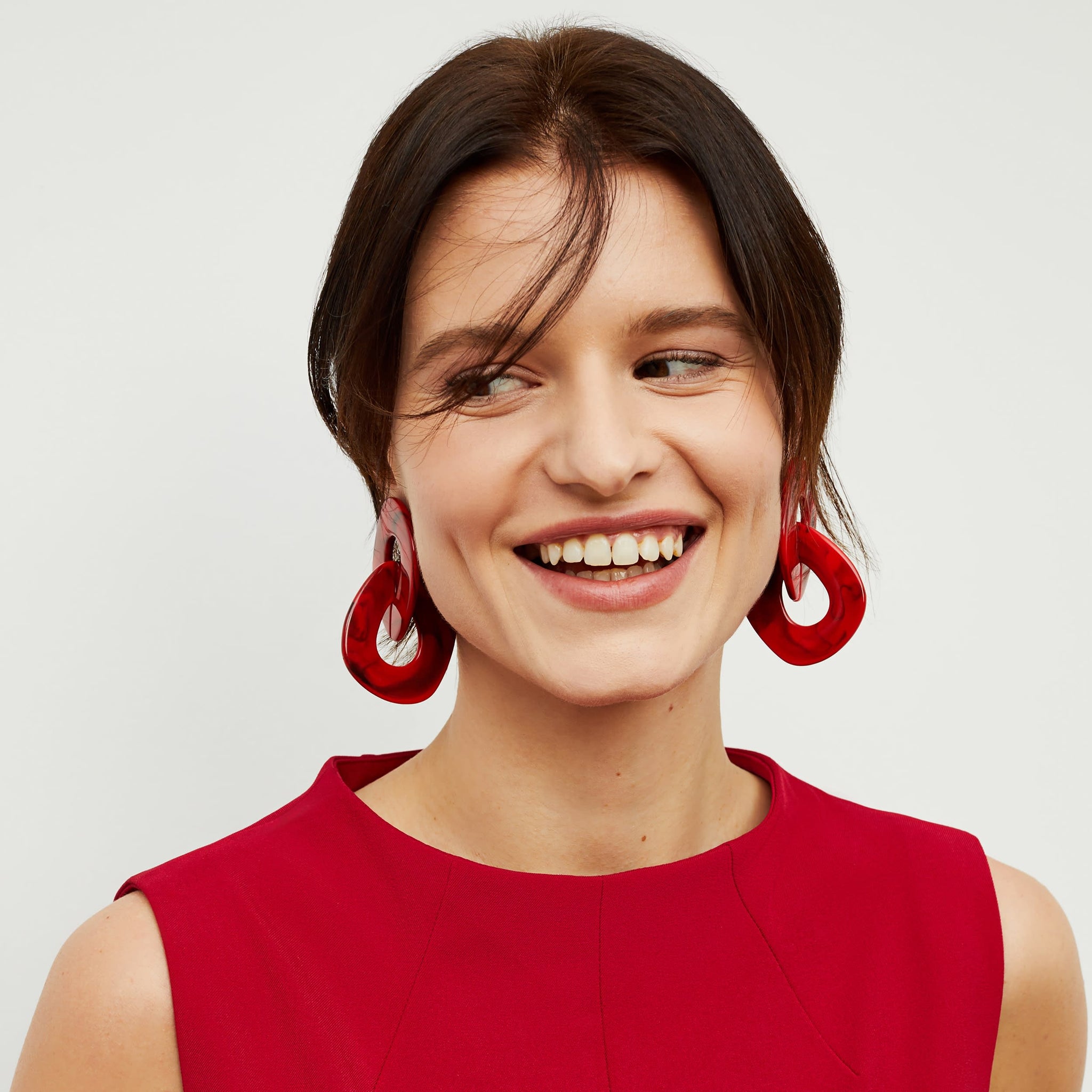 Detail image of a woman standing wearing the Malala Dress—Recycled WonderTex in Rhubarb