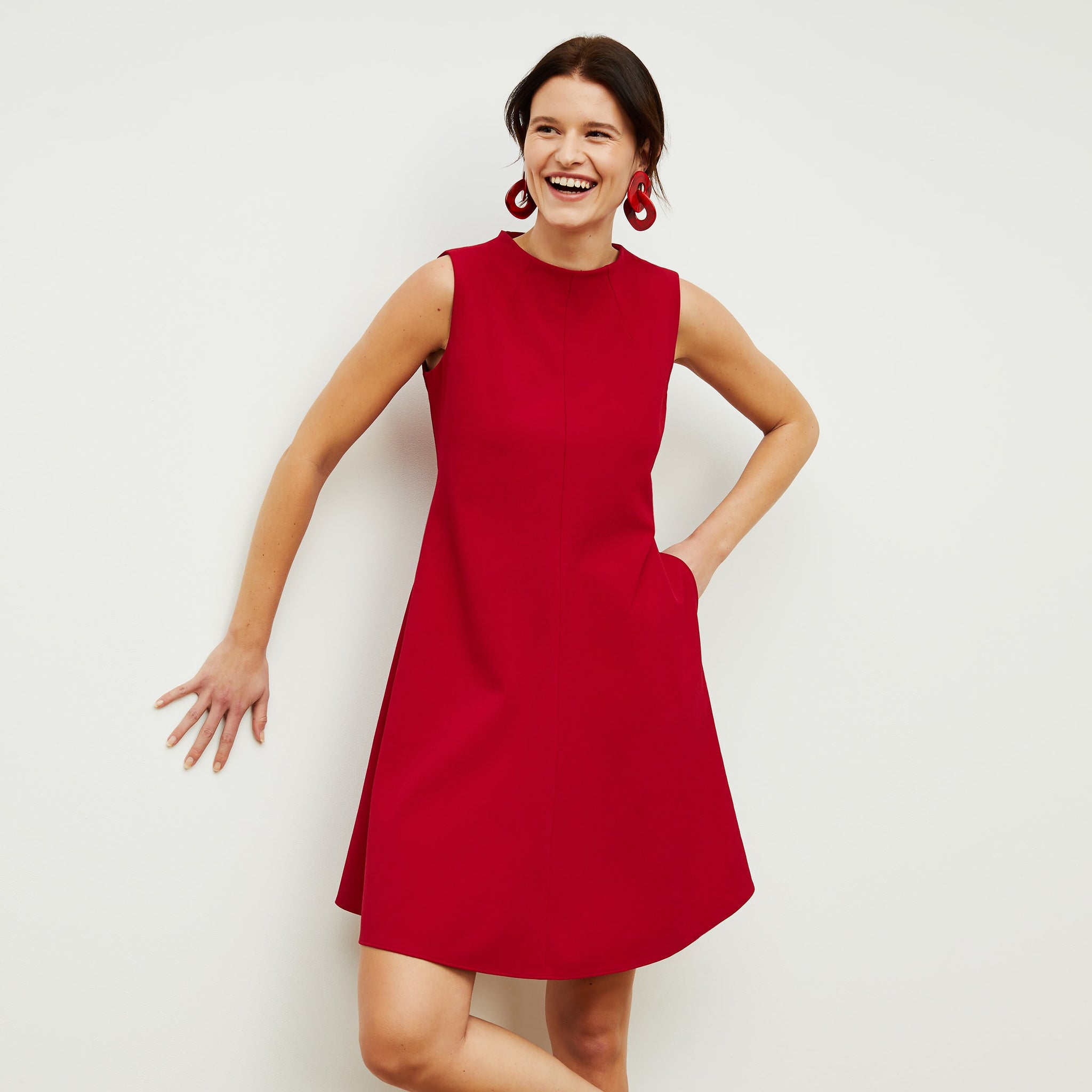 Front image of a woman standing wearing the Malala Dress—Recycled WonderTex in Rhubarb