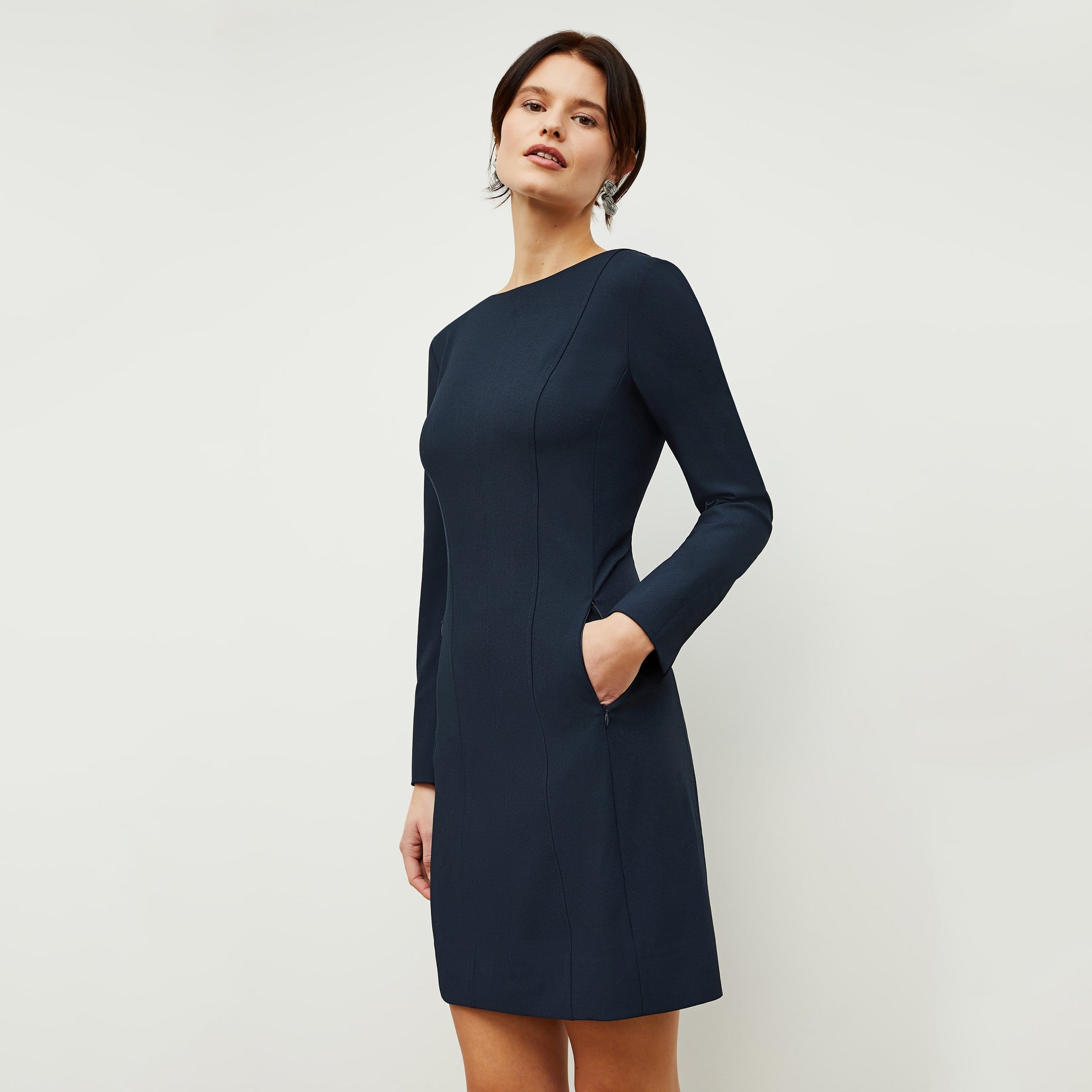 Side image of a woman standing wearing the Novara Dress—Recycled WonderTex in Midnight 