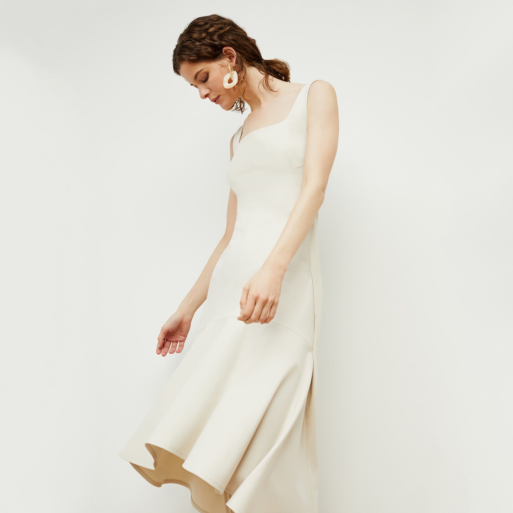 Side image of a woman standing wearing the james dress in pearl