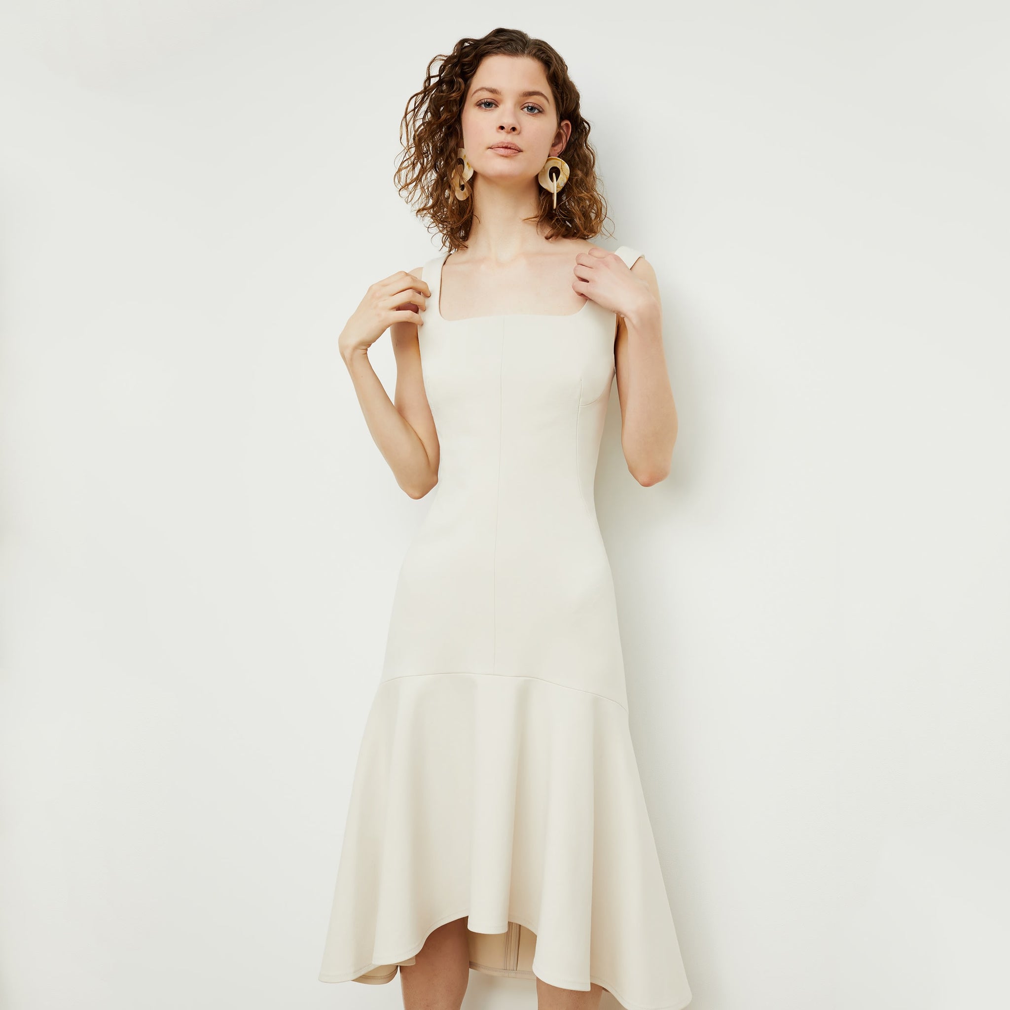 Front image of a woman standing wearing the james dress in pearl 