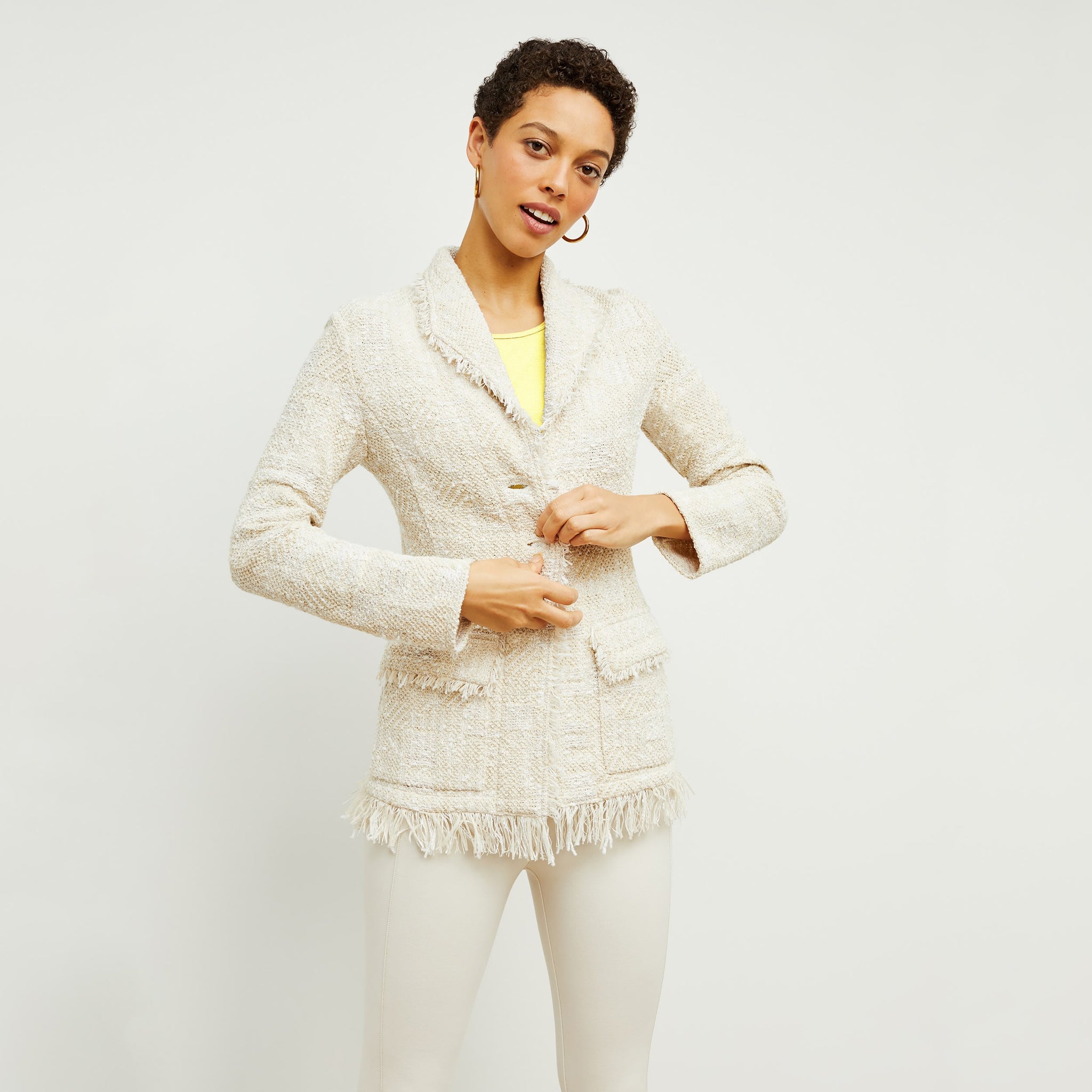 Front image of a woman standing wearing the porter jacket in taupe and ivory