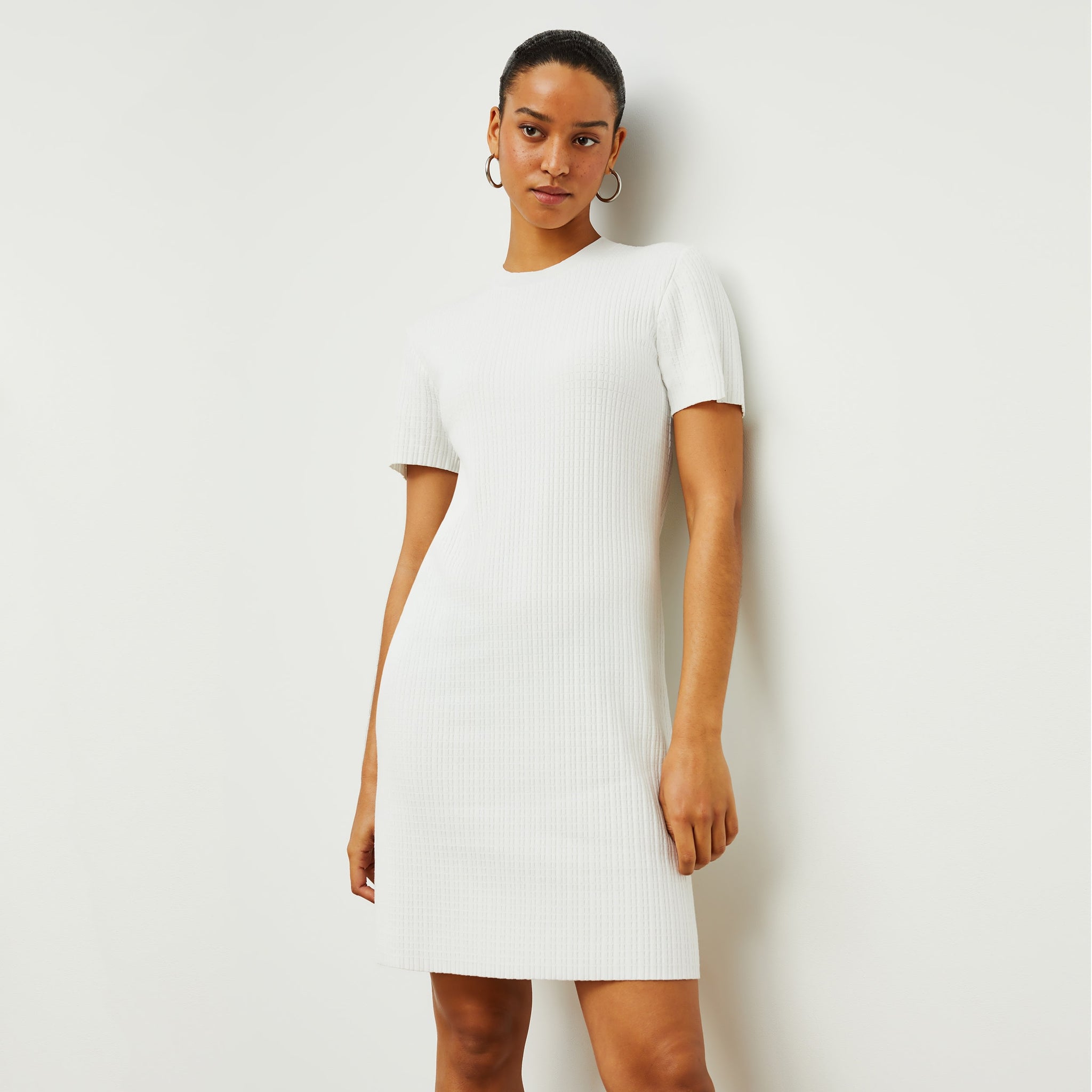 Front image of a woman standing wearing the hayden dress in ivory 