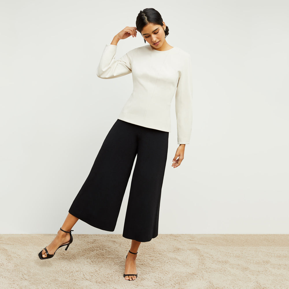 Front image of a woman standing wearing the Rogala Pant—Jardigan Knit in Black