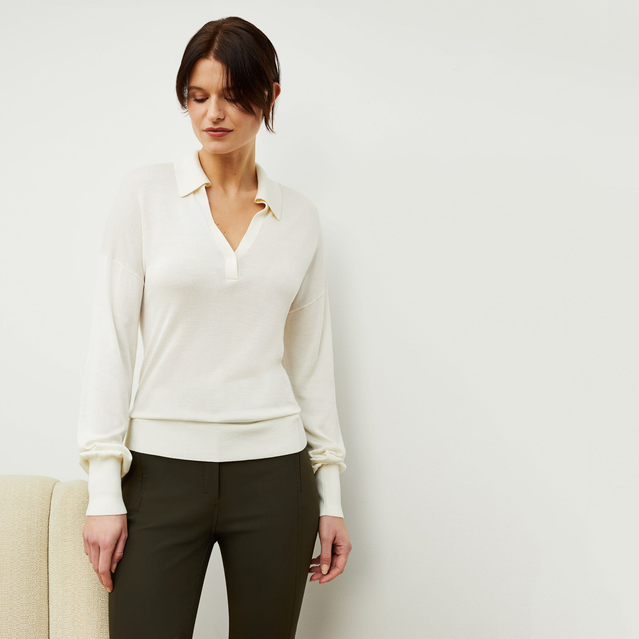 Front image of a woman standing wearing the leo top in cream