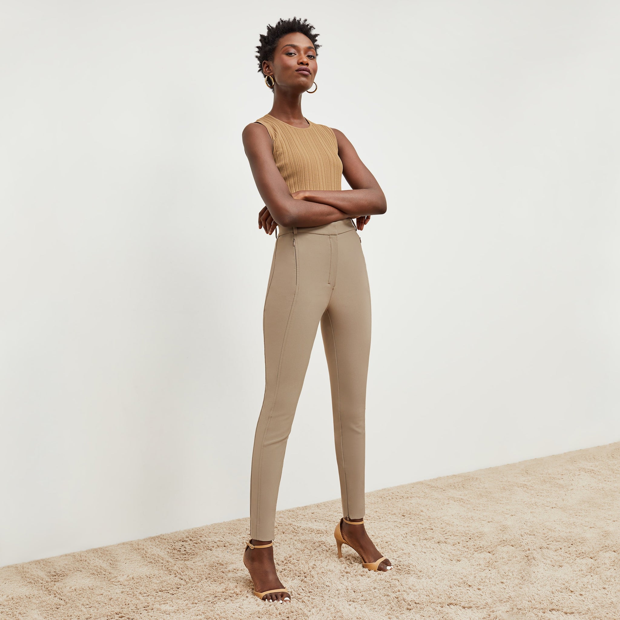 Side image of a woman standing wearing the curie pant in russet 