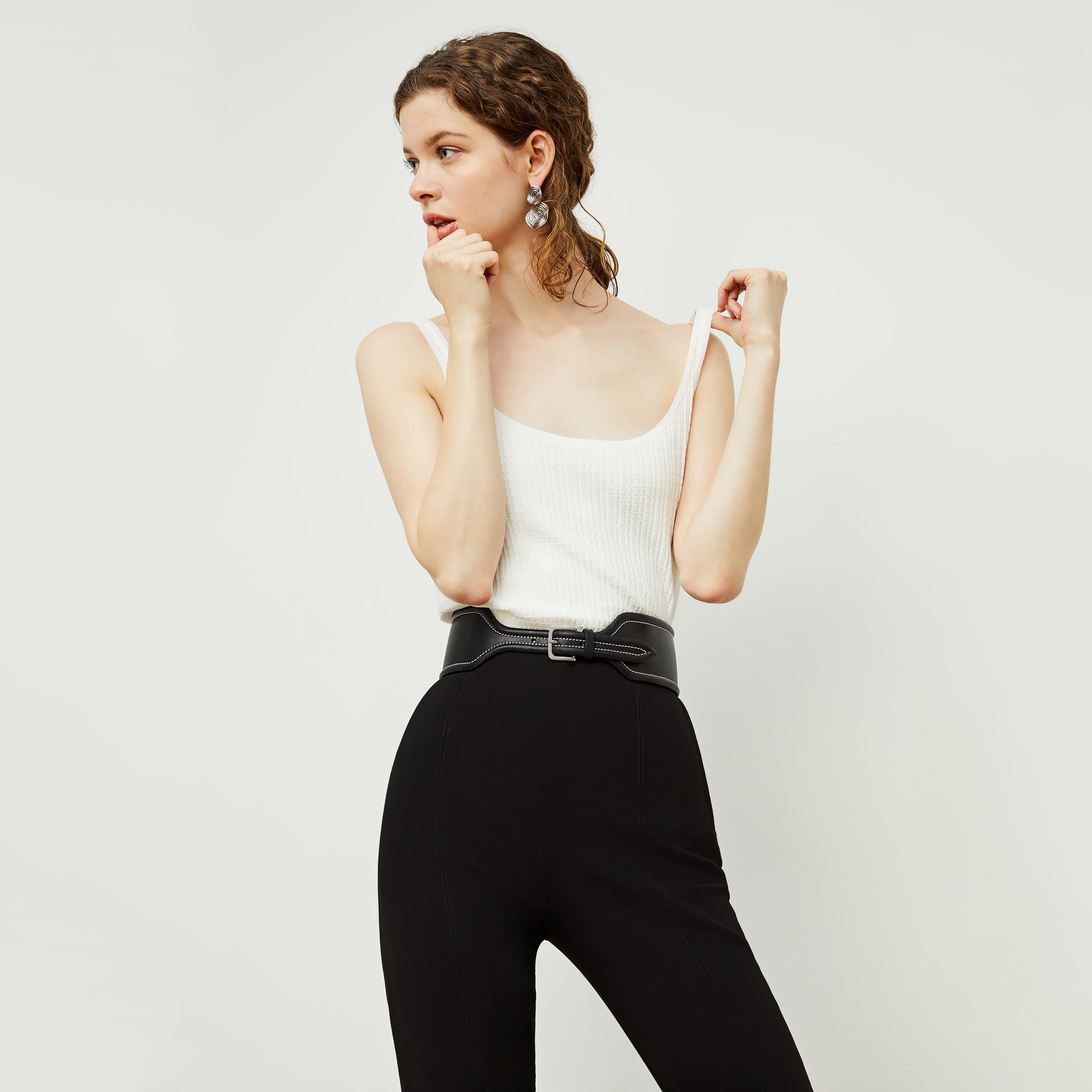 Front image of a woman standing wearing the Marais pant in black
