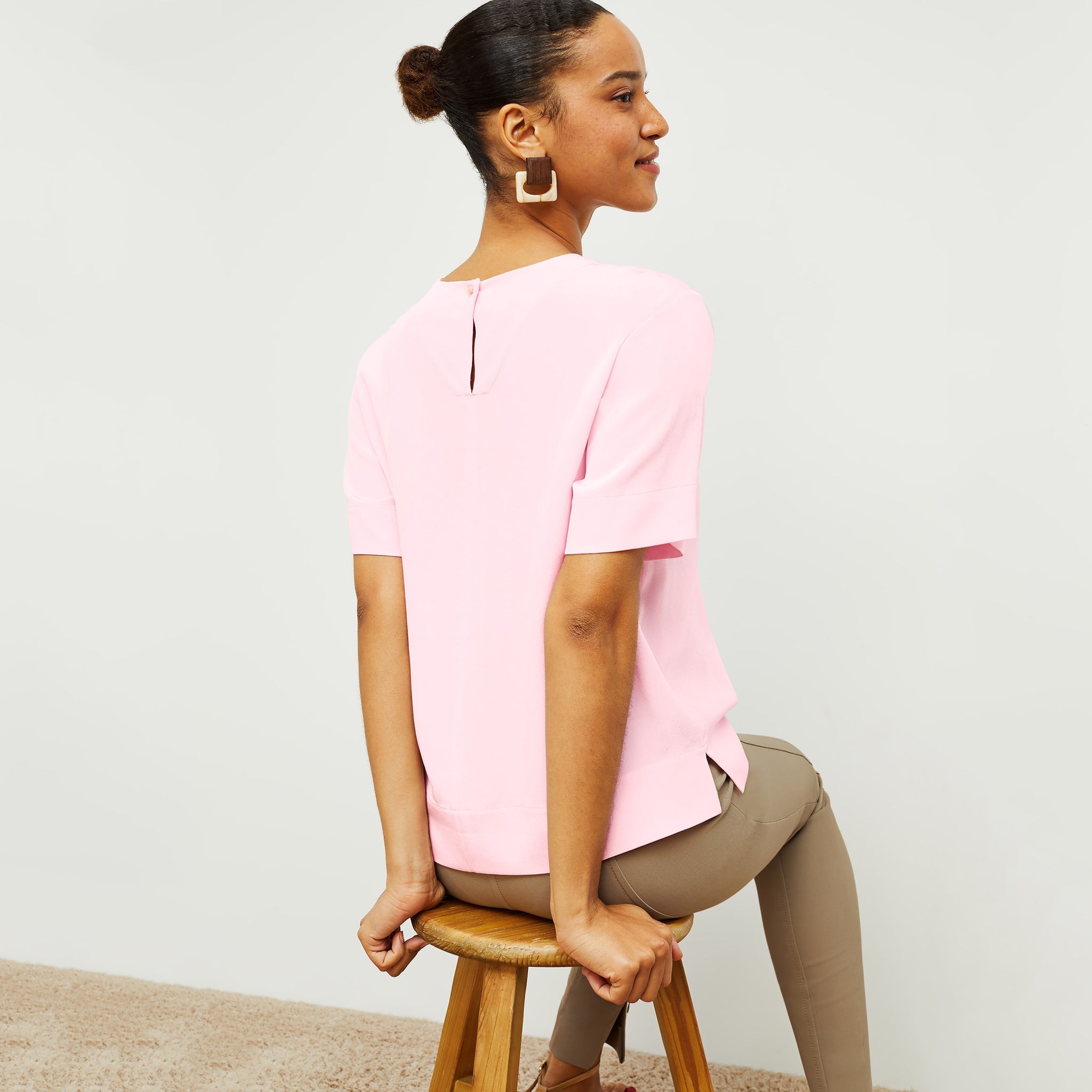 Back image of a woman standing wearing the Annika Tee—Washable Silk in Rosewater