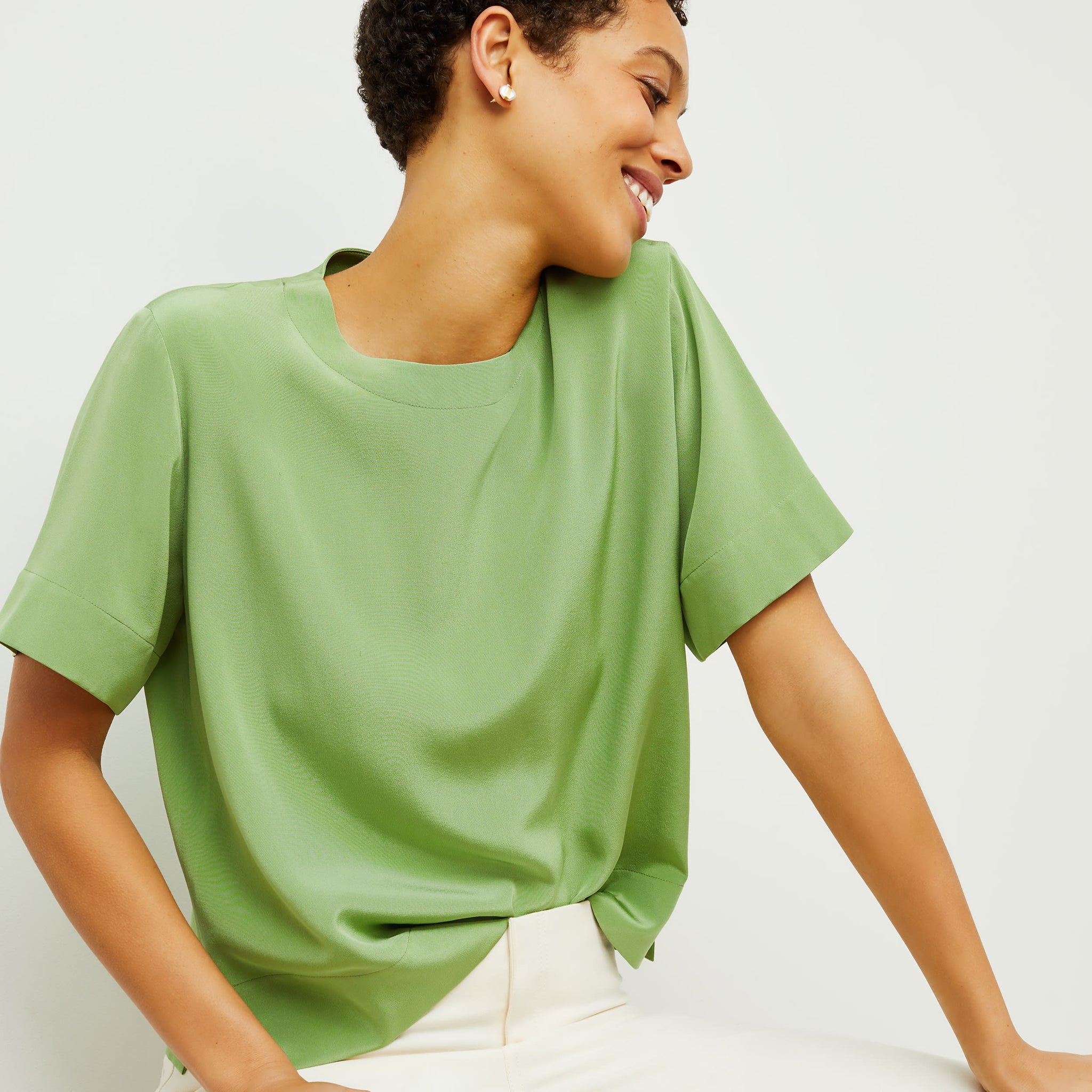 Front image of a woman standing wearing the Annika Tee—Washable Silk in Cactus