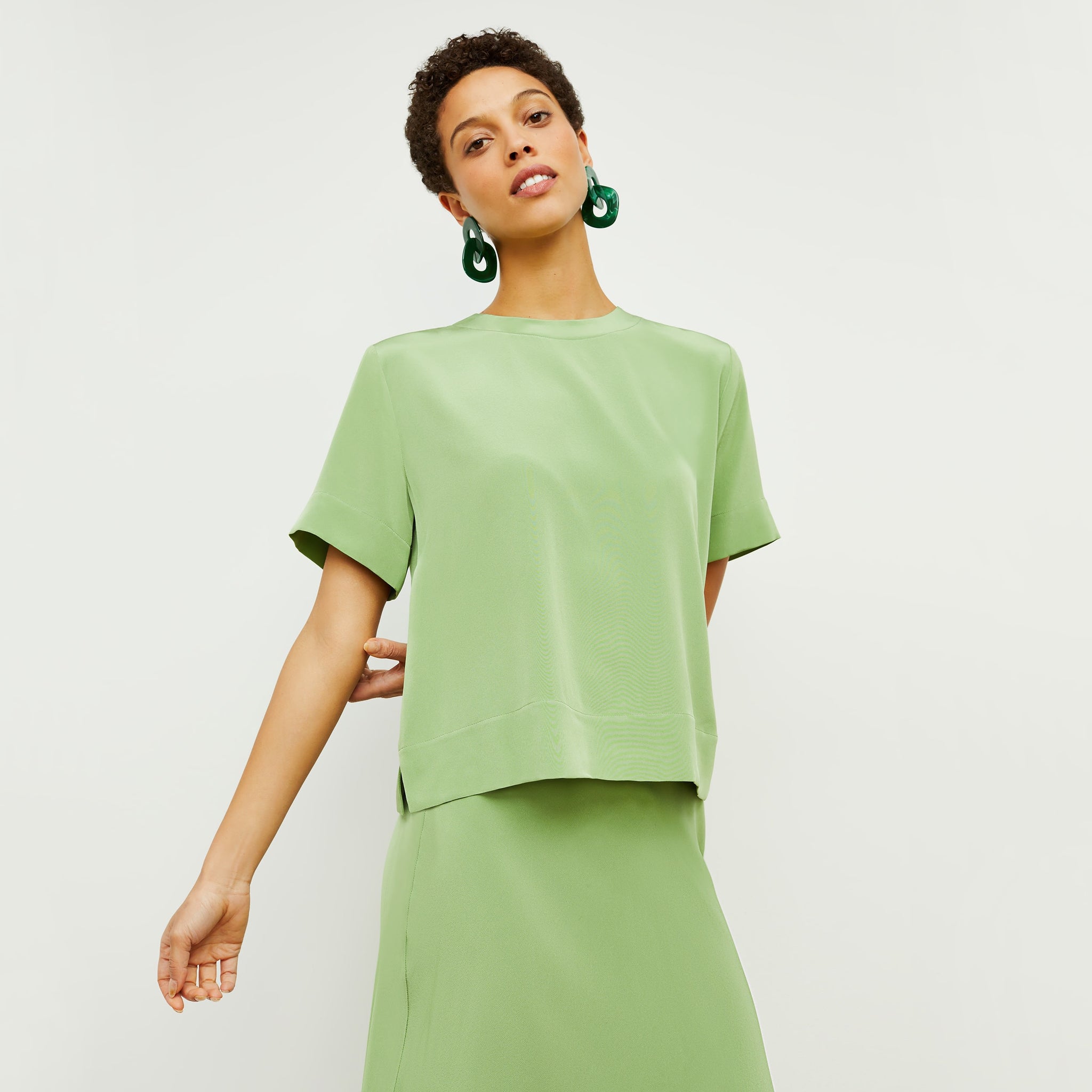 Front image of a woman standing wearing the Annika Tee—Washable Silk in Cactus 