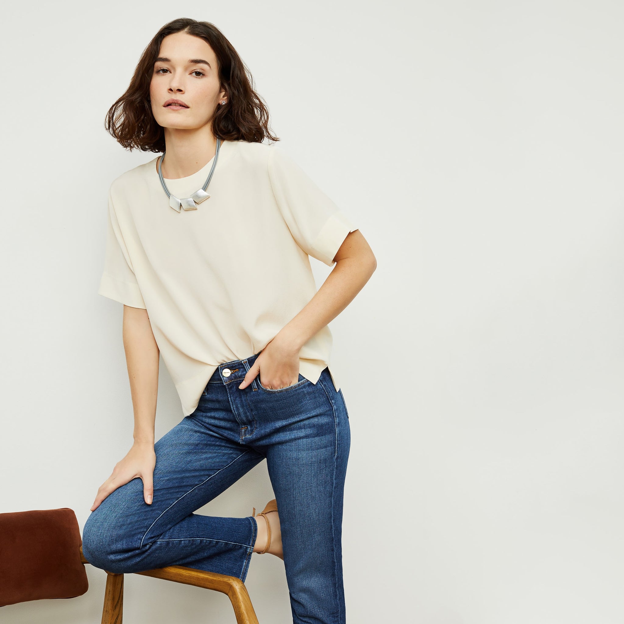 Front image of a woman standing wearing the Annika Tee—Washable Silk in Pearl 