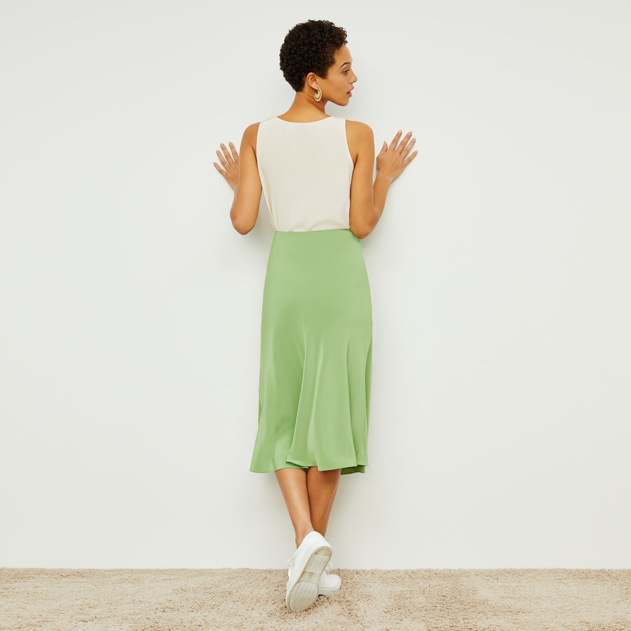 Back image of a woman standing wearing the Orchard Skirt—Washable Silk in Cactus