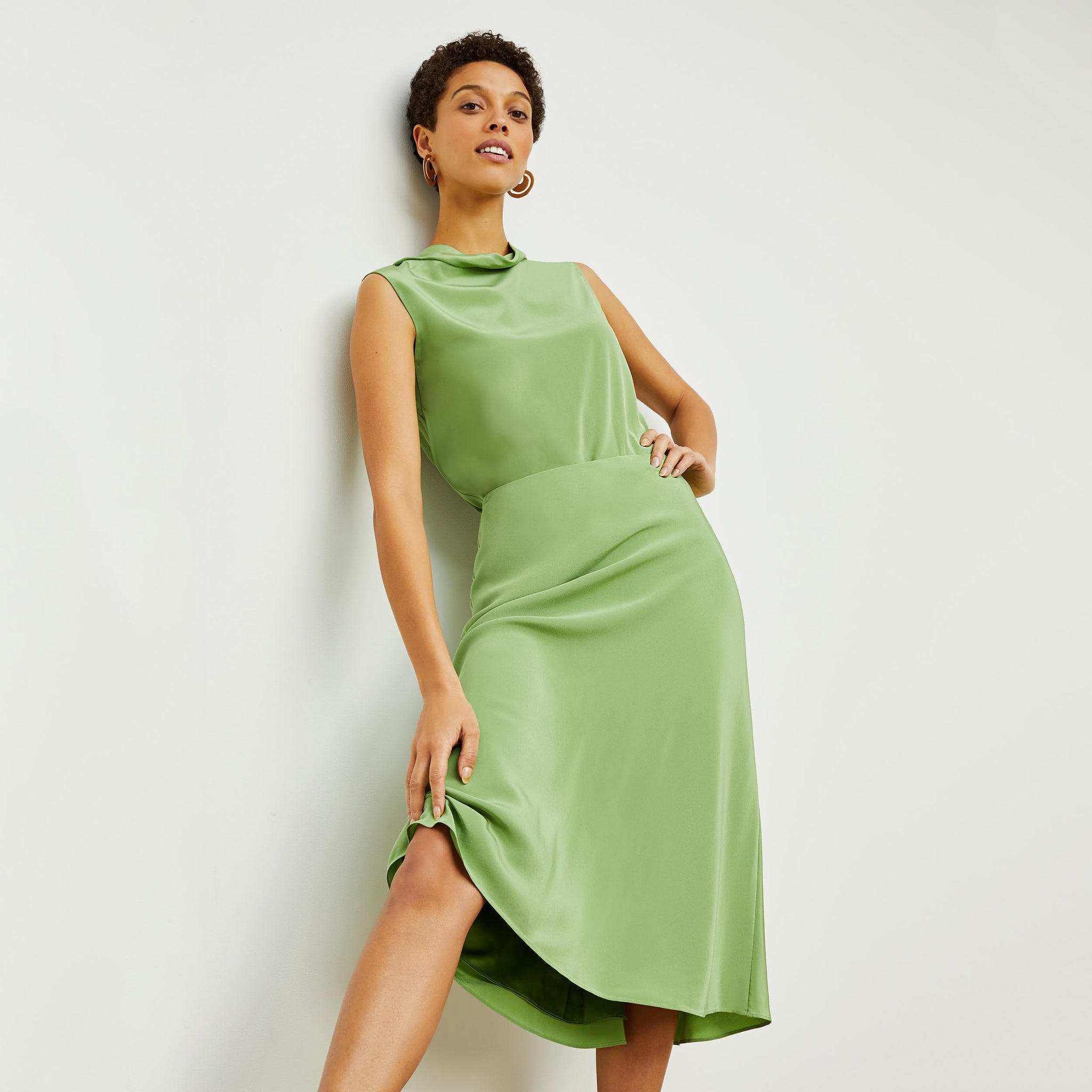 Front image of a woman standing wearing the Orchard Skirt—Washable Silk in Cactus