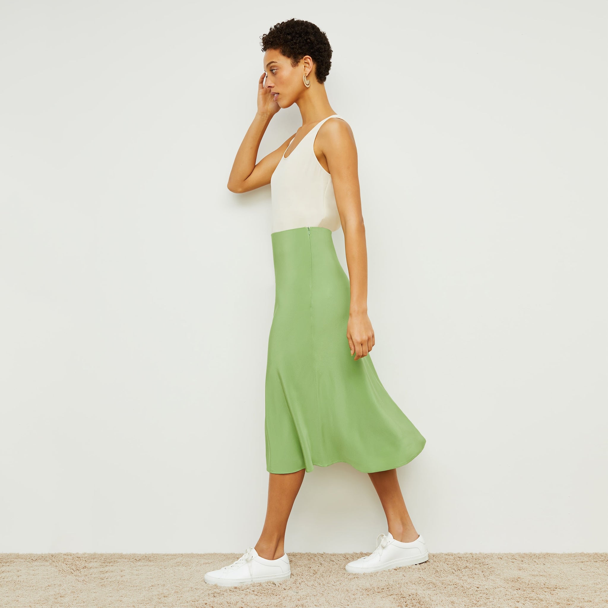 Side image of a woman standing wearing the Orchard Skirt—Washable Silk in Cactus