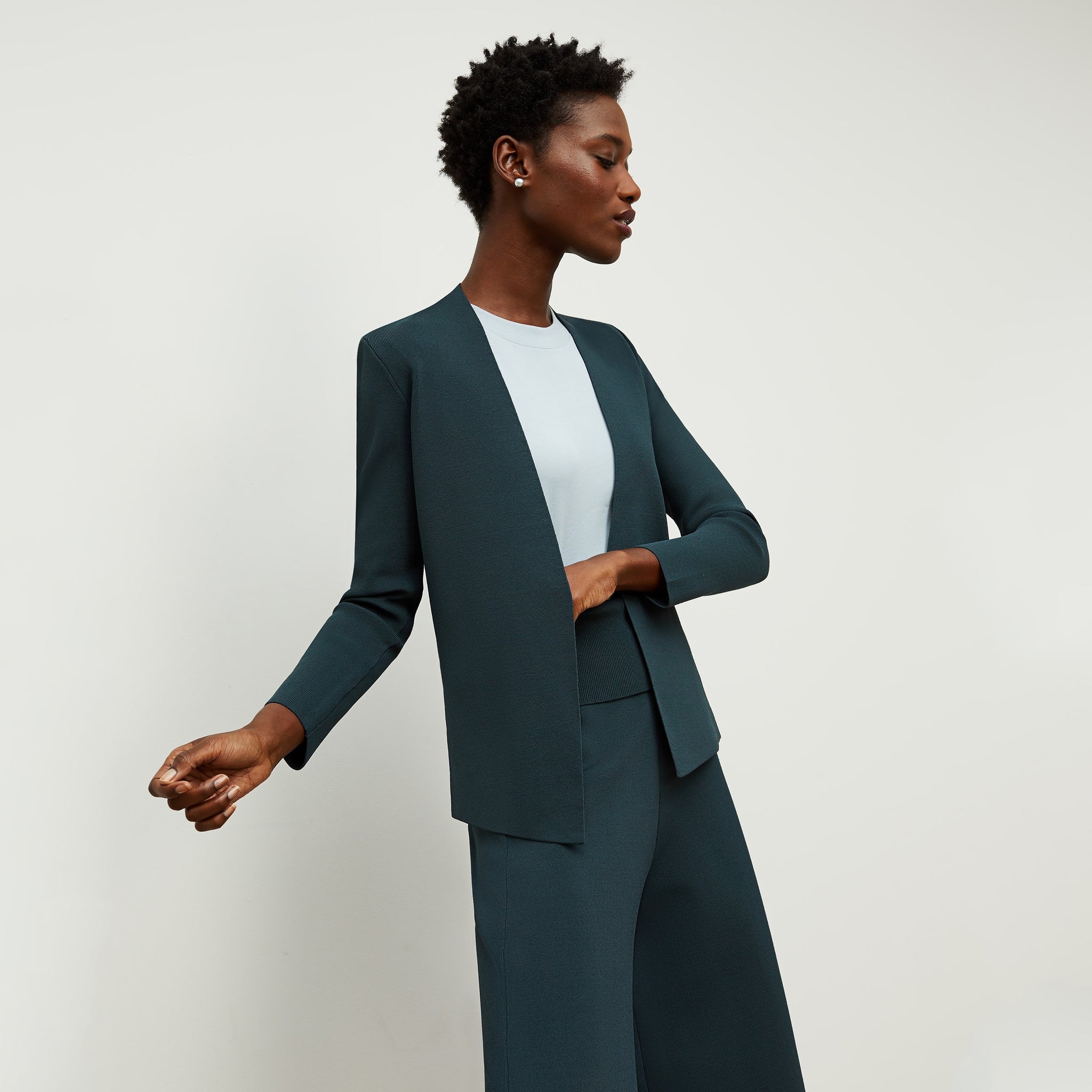 Front image of a woman standing wearing the Alina T-Shirt—Compact Cotton in Sky Blue